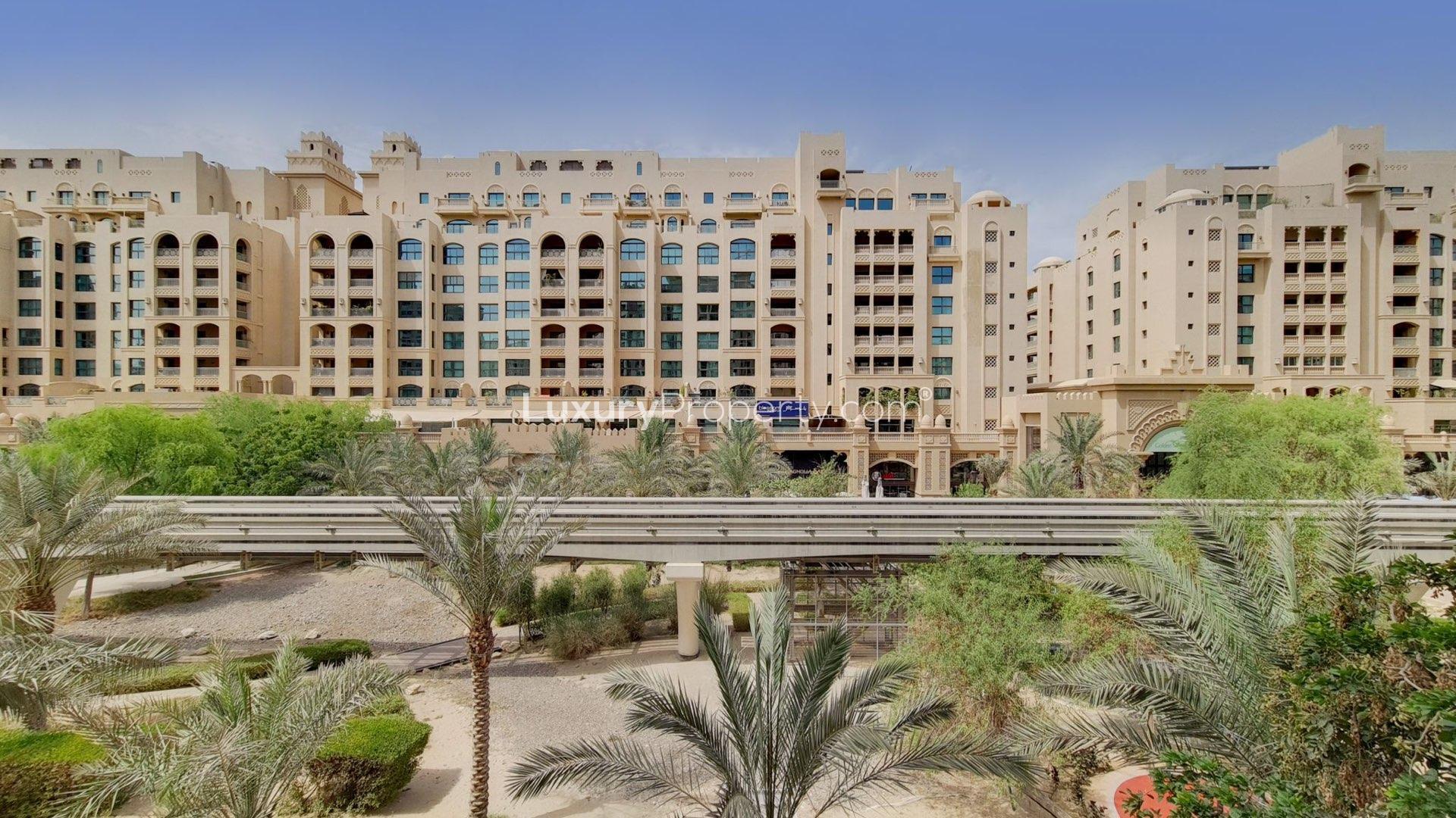 Exterior view of Shoreline Apartments, Palm Jumeirah, Dubai, showcasing lush landscaping