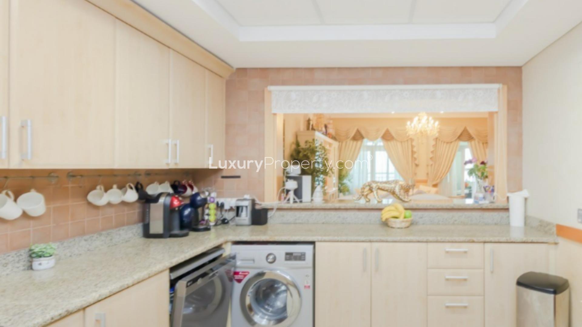 Luxurious living room in Shoreline Apartment, Palm Jumeirah with elegant decor and chandelier