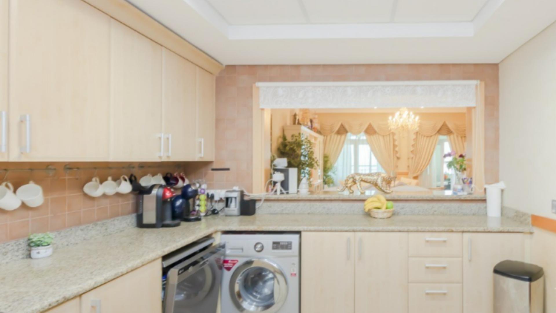 Luxurious living room in Shoreline Apartment, Palm Jumeirah with elegant decor and chandelier