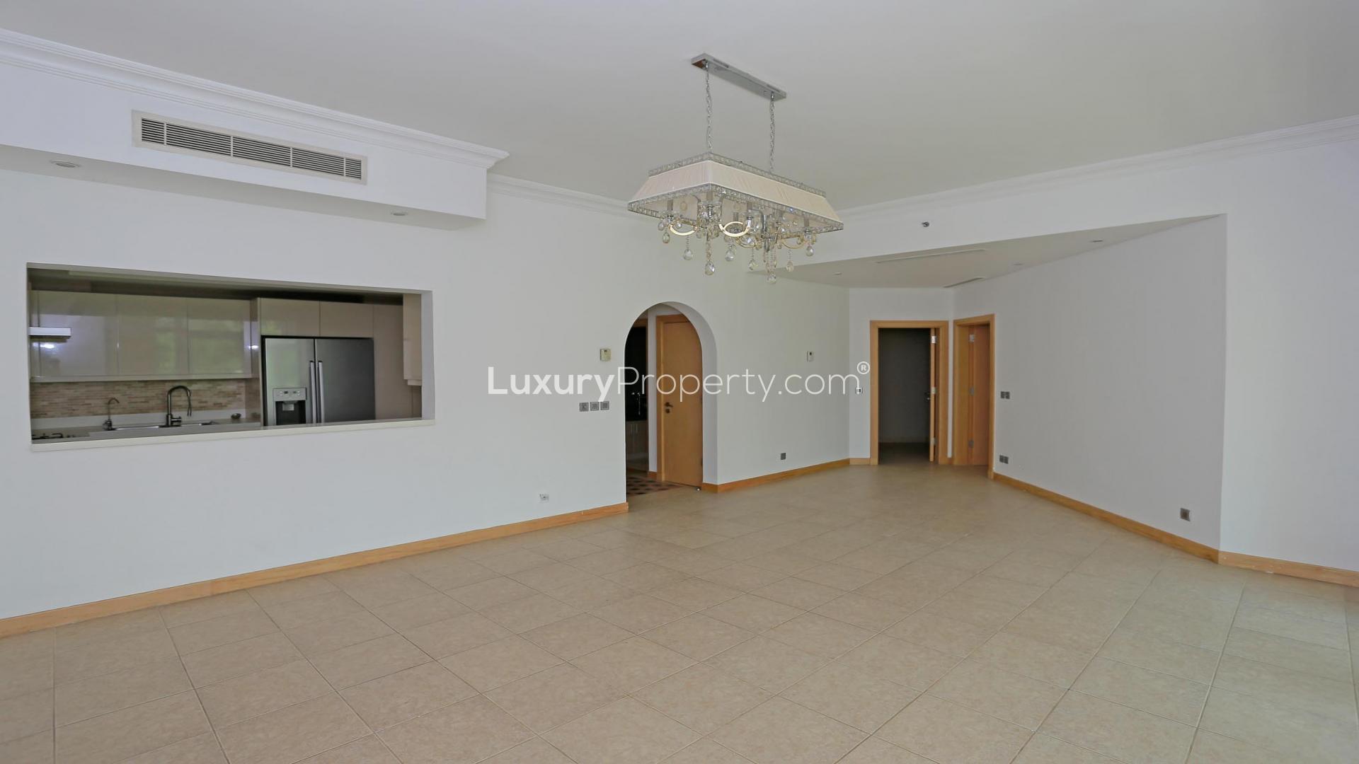 Spacious living area in upgraded Shoreline Apartment, Palm Jumeirah, with large windows and chandelier