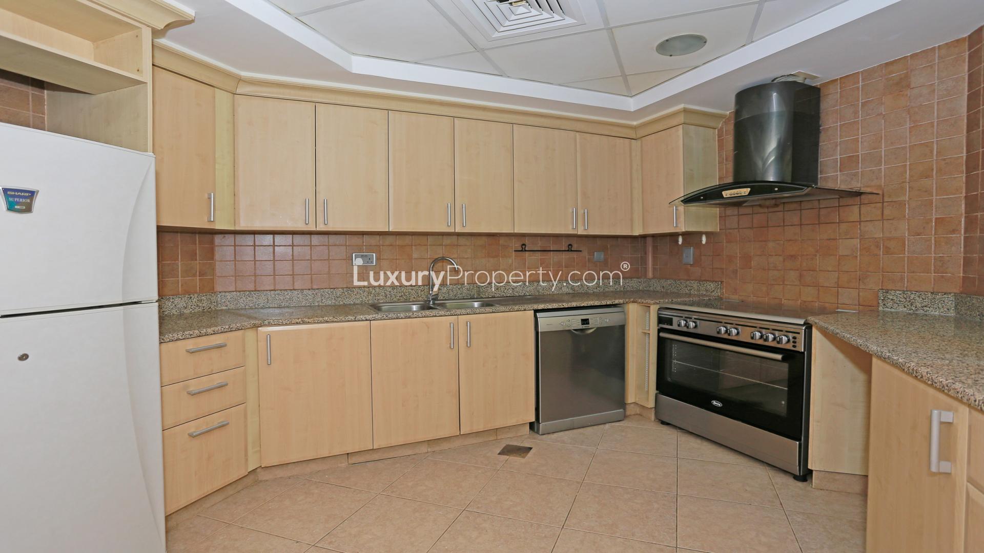 Luxurious Shoreline Apartments in Palm Jumeirah, view of lush greenery and architecture