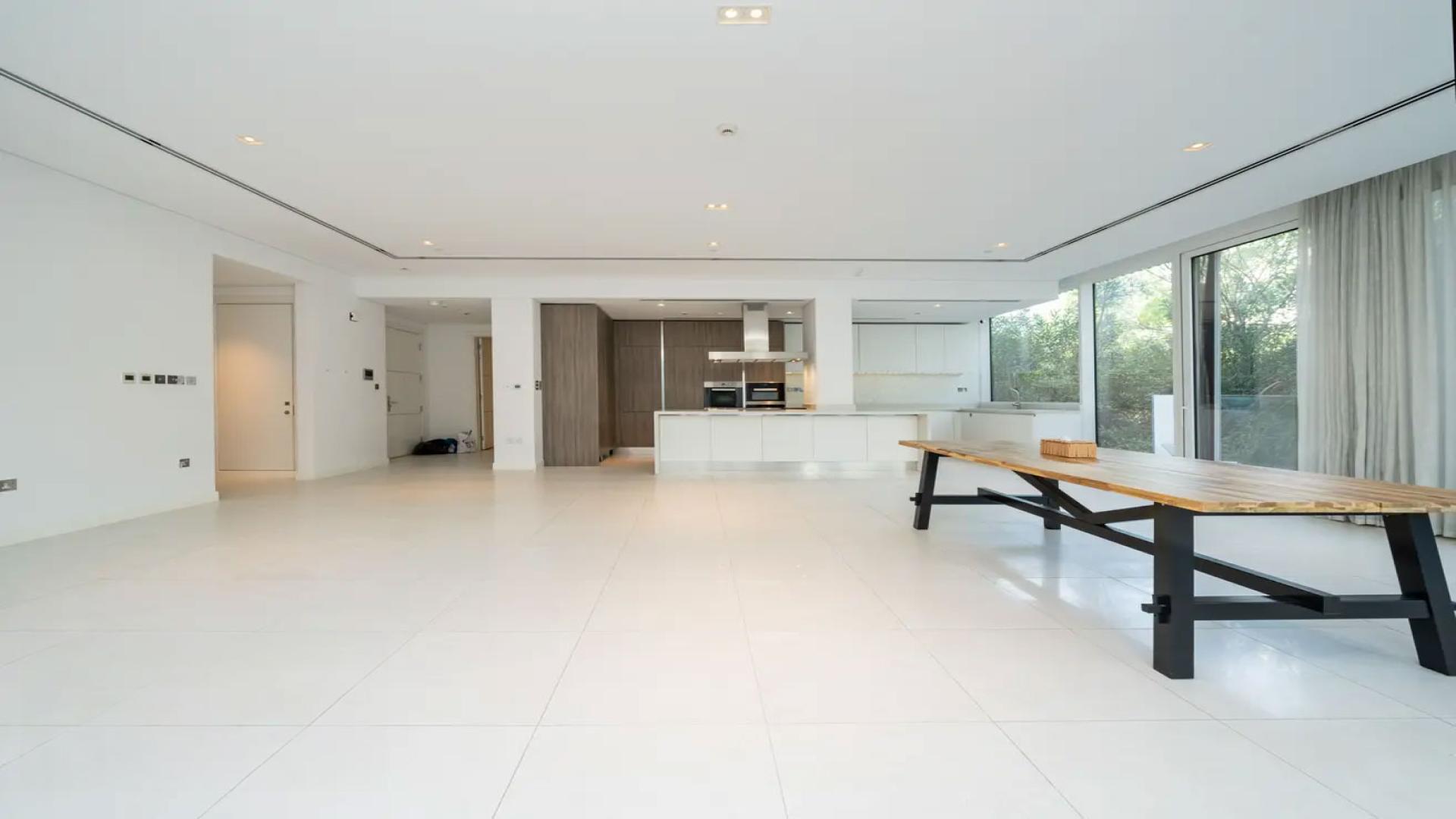 Spacious living room with large windows in Ashjar, Al Barari apartment for rent