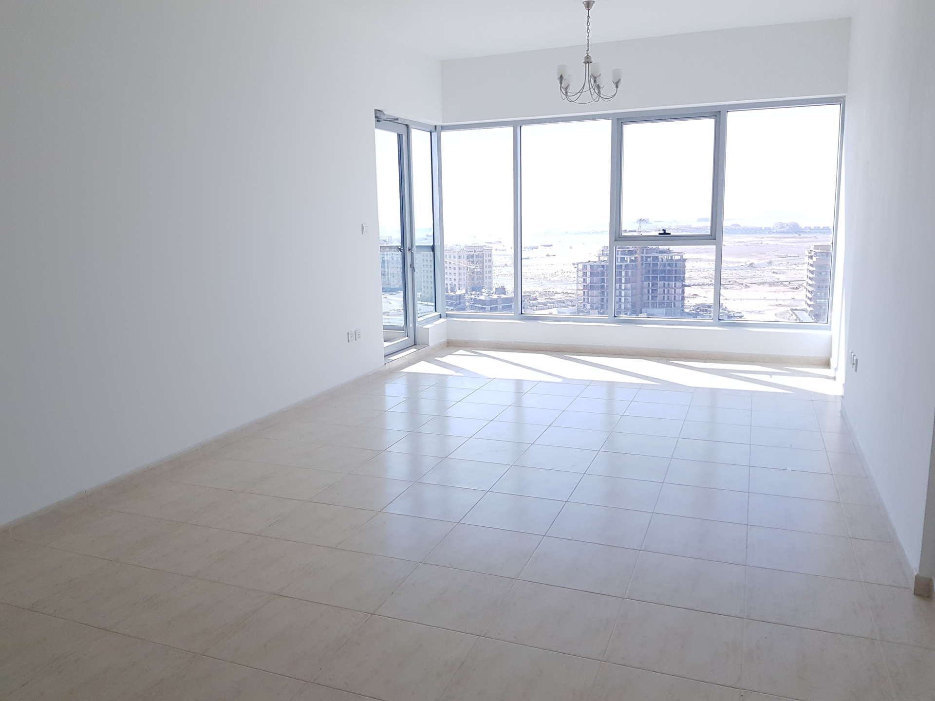 Hallway in spacious 2-bedroom apartment, Skycourt Towers, Dubailand, featuring wooden doors and tiled floor