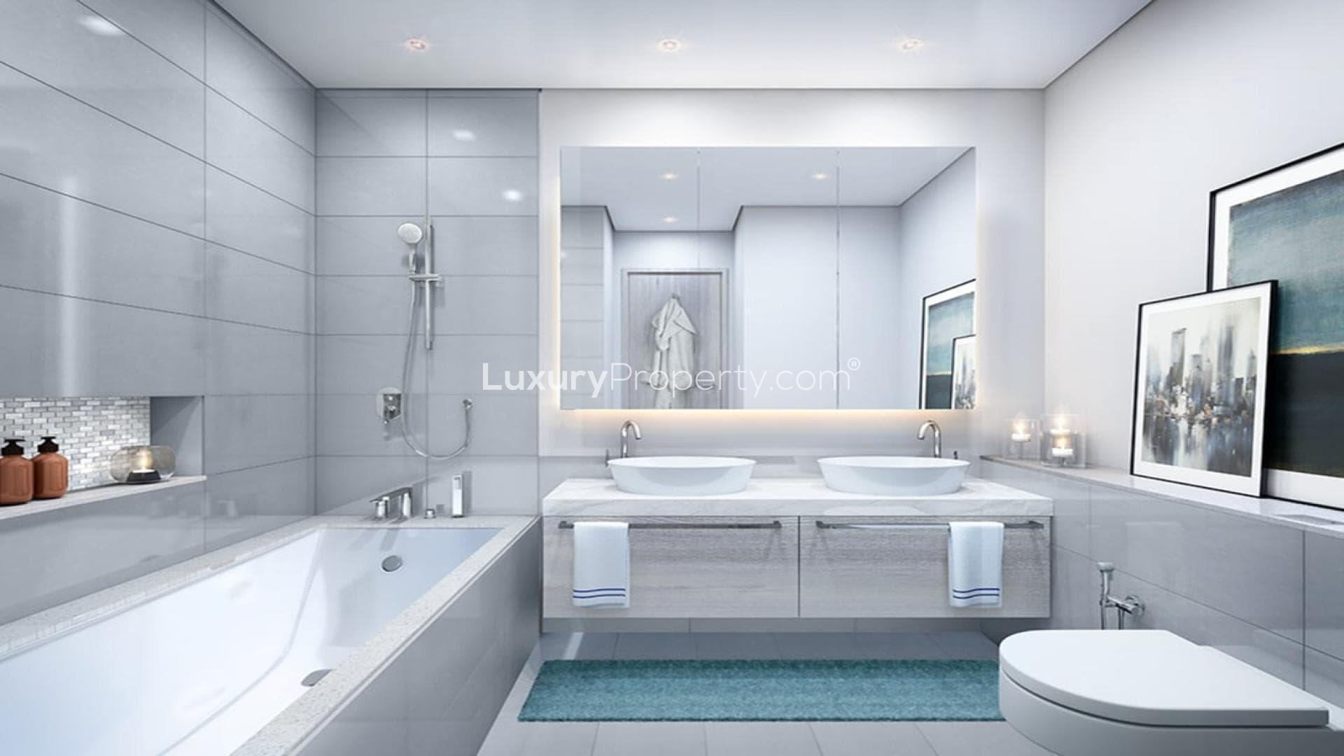 Modern bathroom in 2-bedroom apartment, Dubai Creek Harbour, featuring dual sinks and bathtub