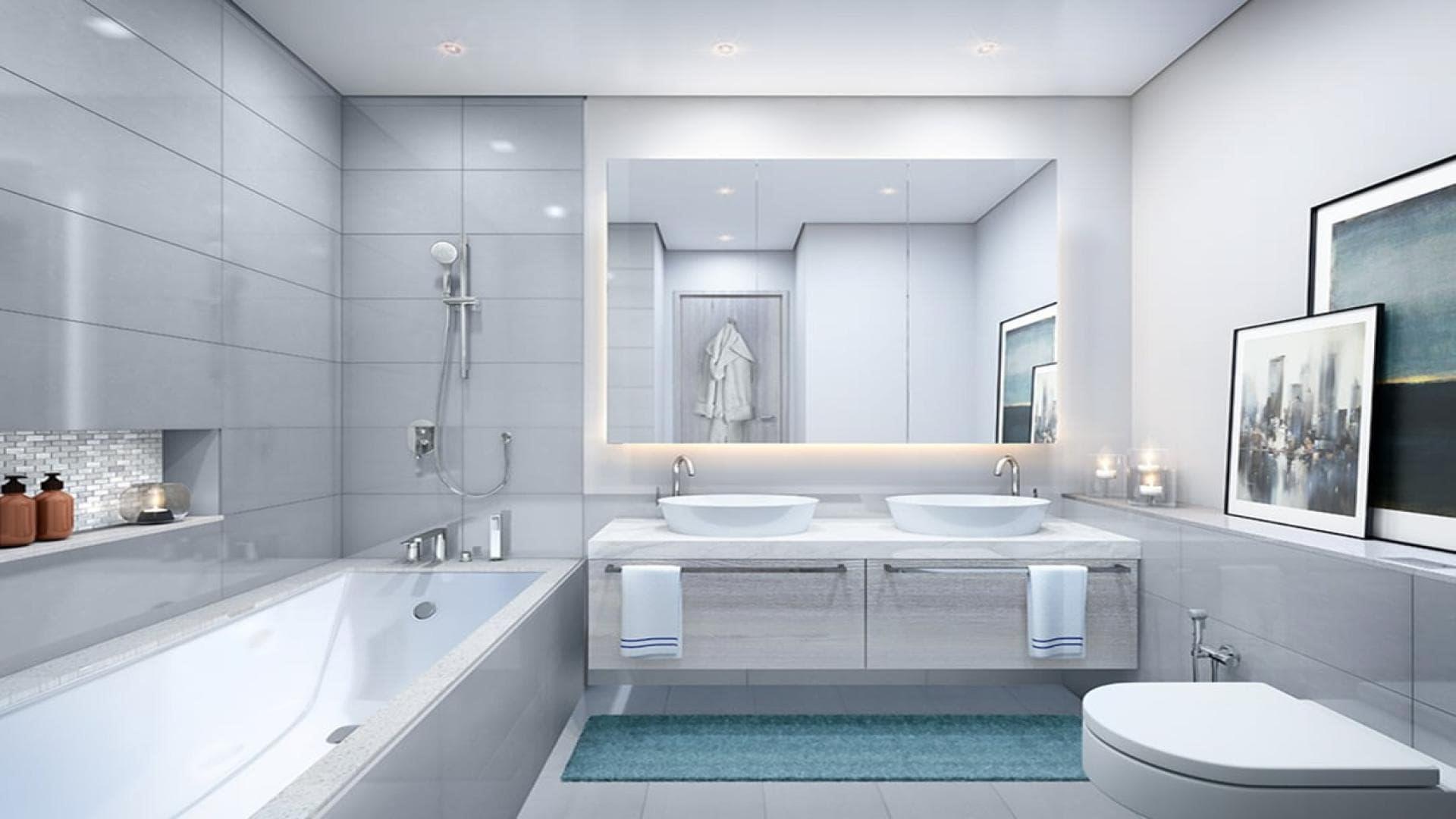 Modern bathroom in 2-bedroom apartment, Dubai Creek Harbour, featuring dual sinks and bathtub