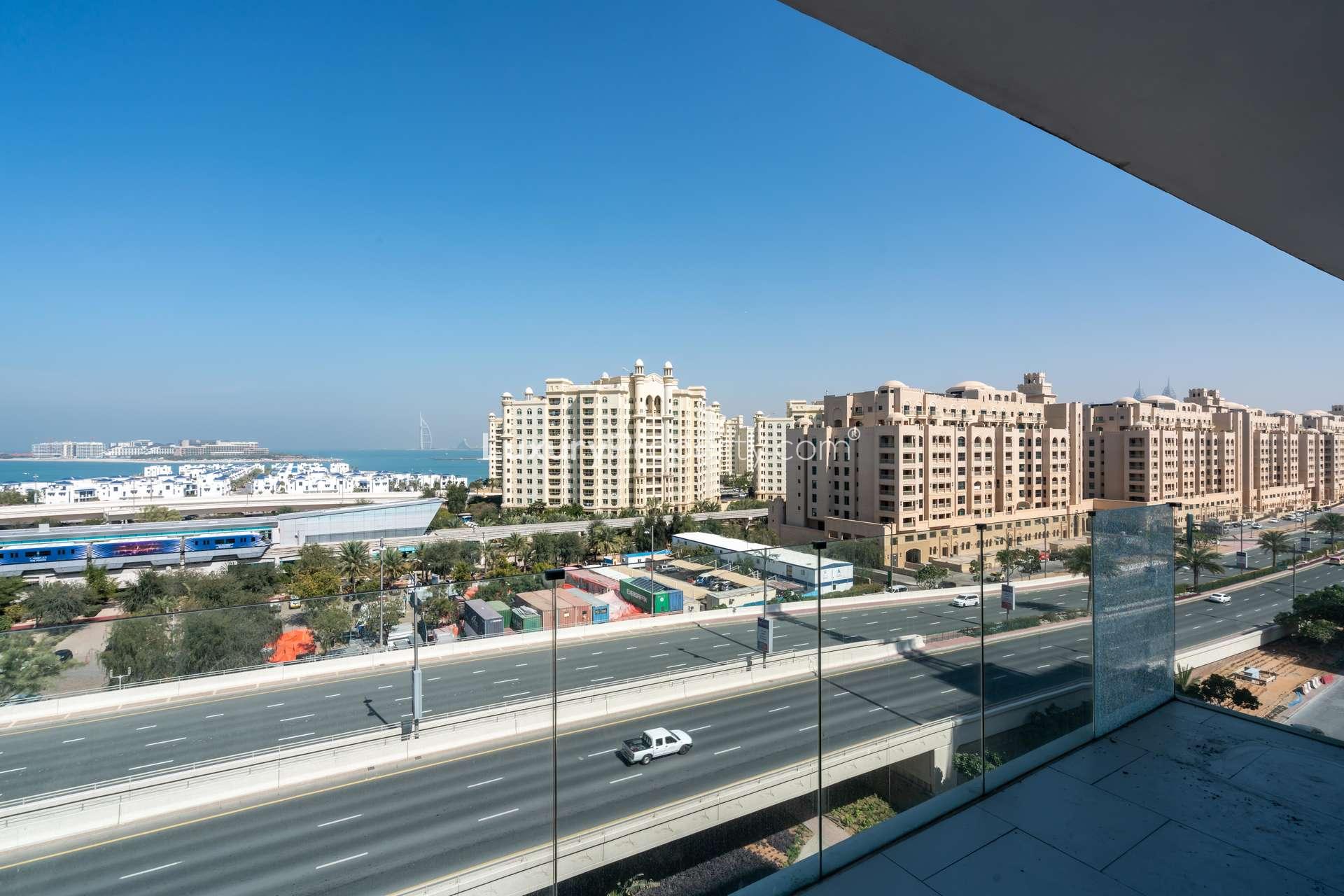 Modern gym in Soho Palm Jumeirah apartment, featuring exercise equipment and panoramic windows