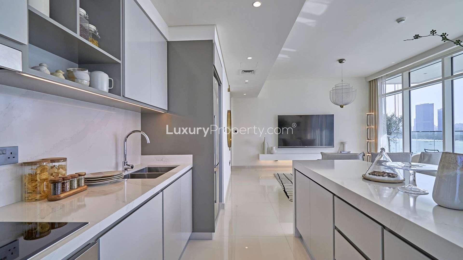Modern bathroom in chic Dubai Harbour apartment, featuring sleek sink and large mirror