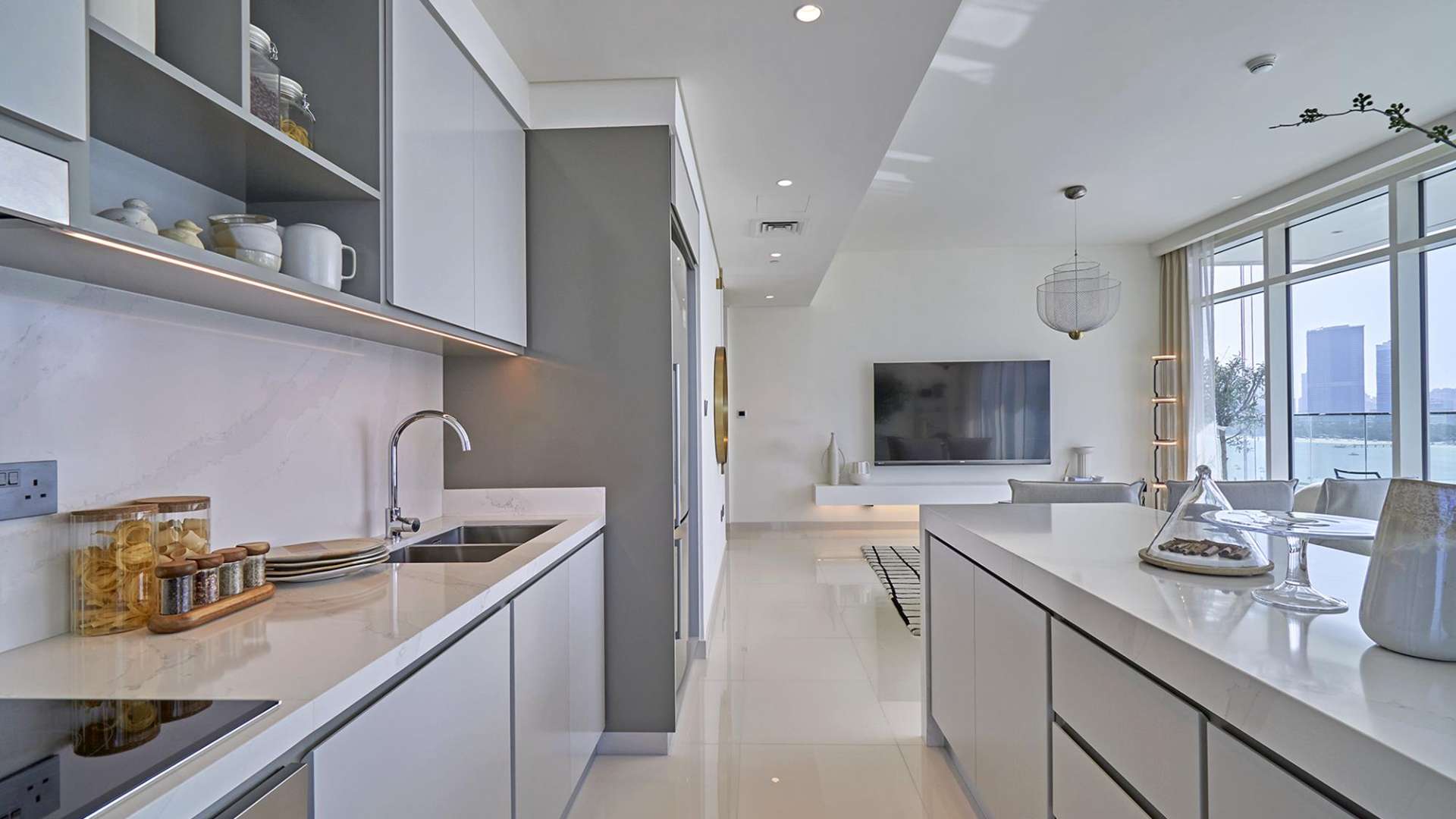 Modern bathroom in chic Dubai Harbour apartment, featuring sleek sink and large mirror
