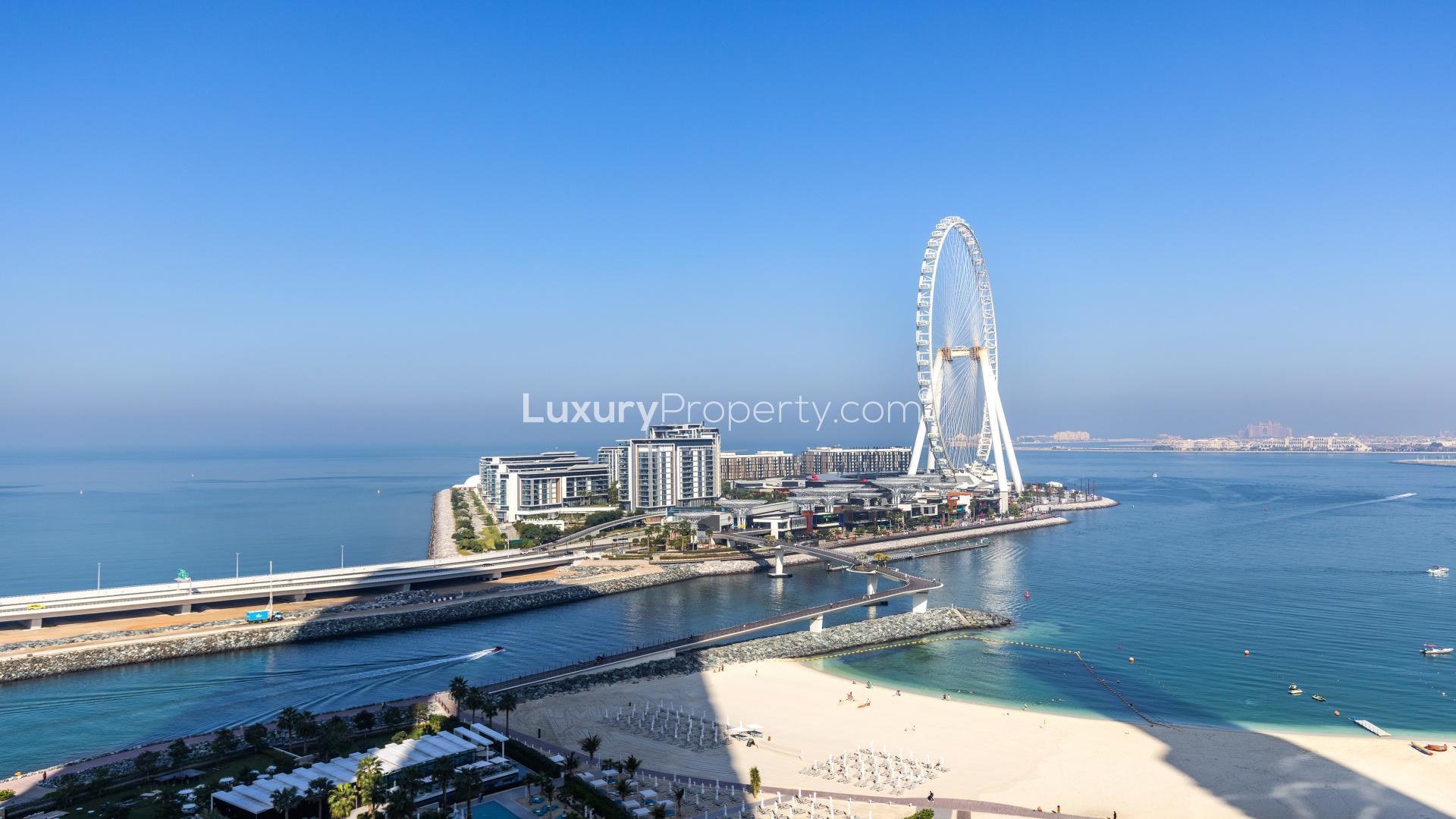 "View from 2-bedroom apartment at The Address Jumeirah, overlooking beach and Ferris wheel.",Modern living room with ocean view at The Address Jumeirah Resort apartment, Jumeirah Beach Residence
