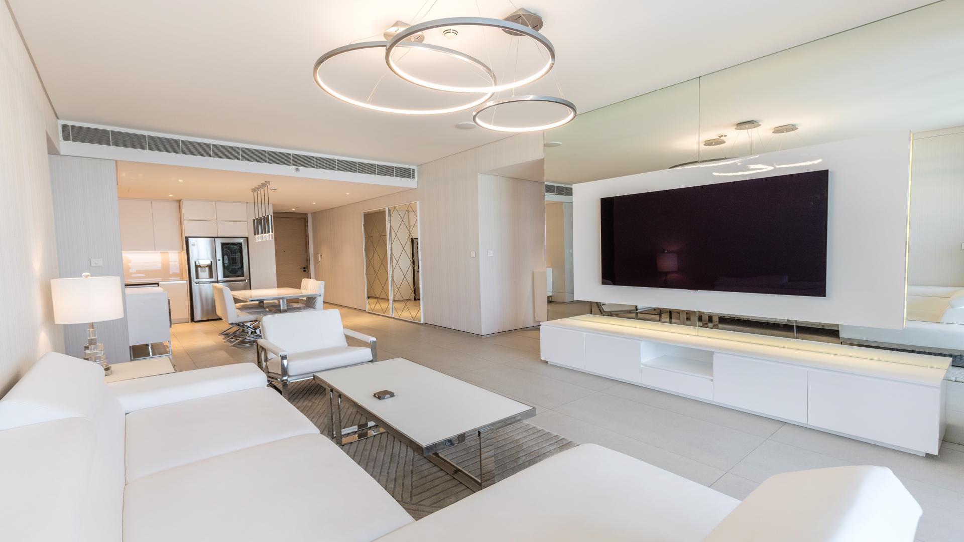 "Balcony view from 2-bedroom apartment at The Address Jumeirah Resort, overlooking beach and skyline.",Modern living room in 2-bedroom apartment at The Address Jumeirah, Jumeirah Beach Residence