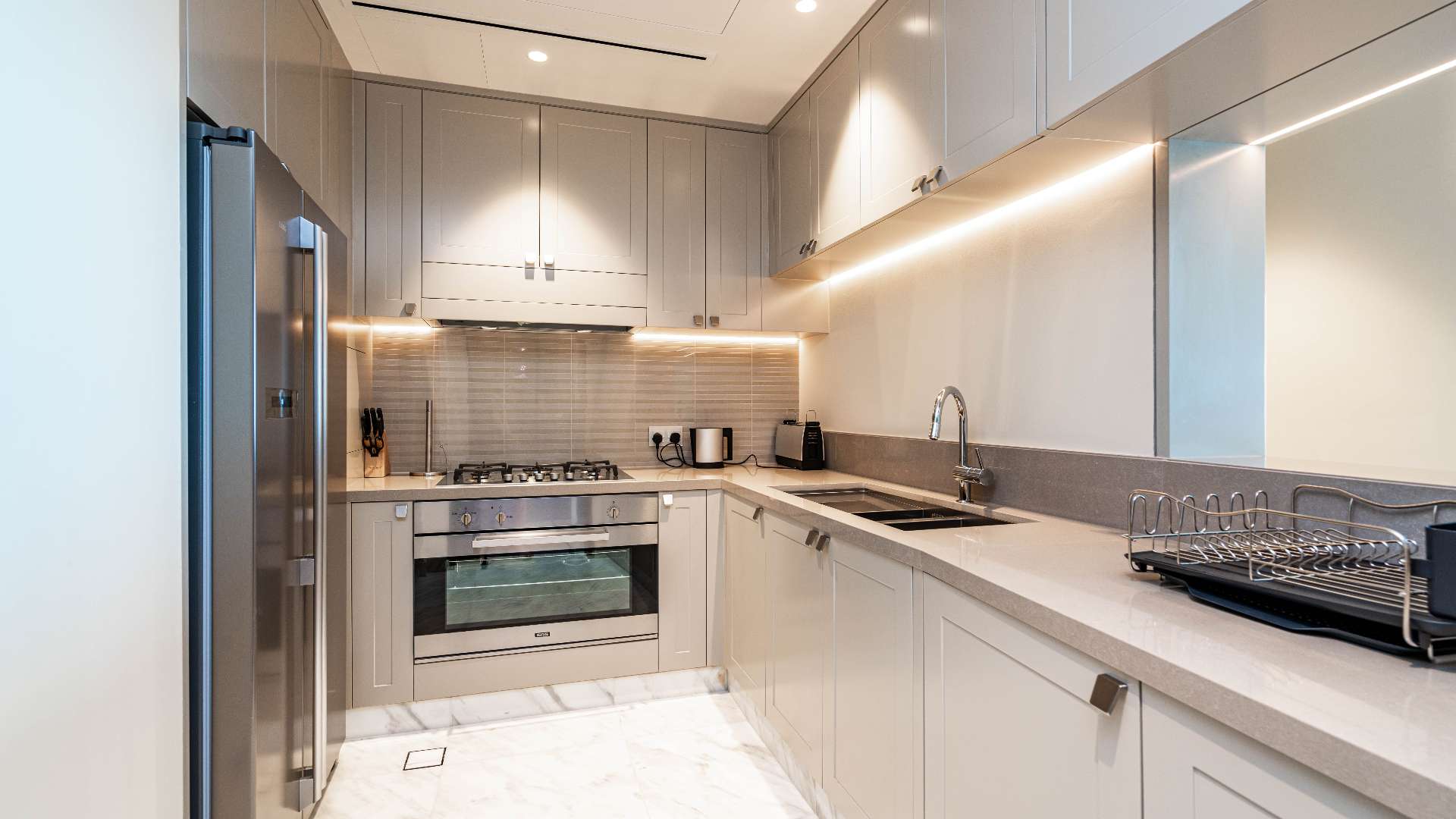 Fully furnished Dubai Downtown apartment living room with city view, modern decor, and TV