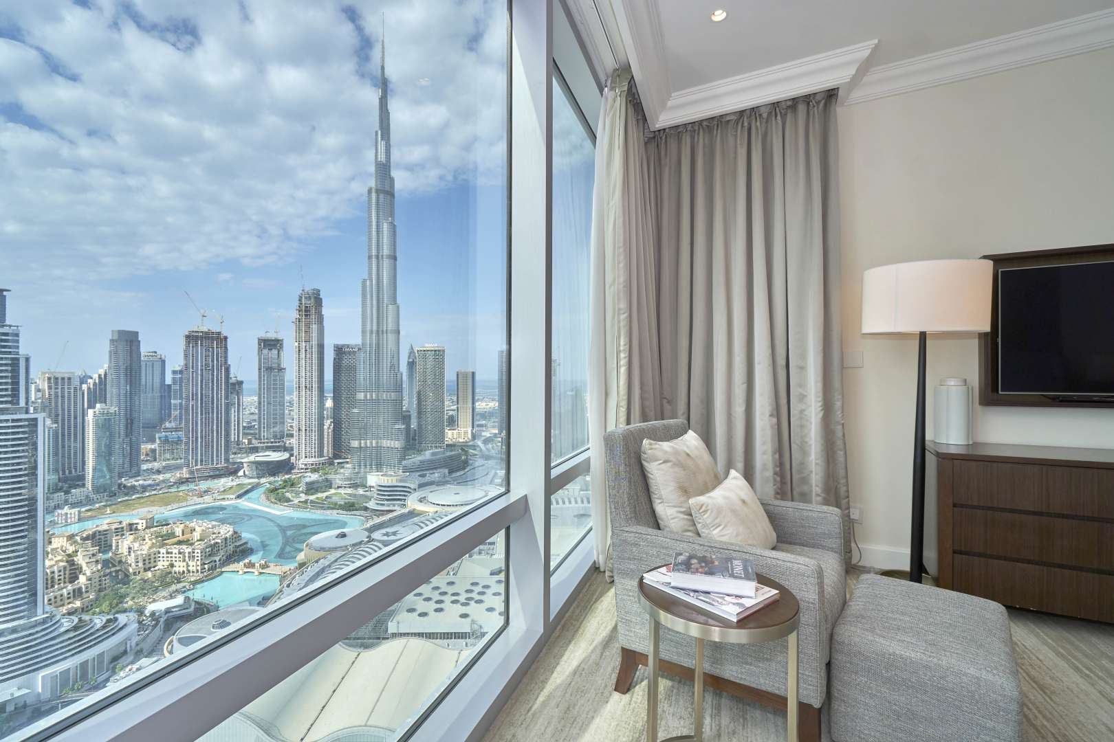 Luxury bedroom in Downtown Dubai apartment with Burj Khalifa views, modern decor, natural light