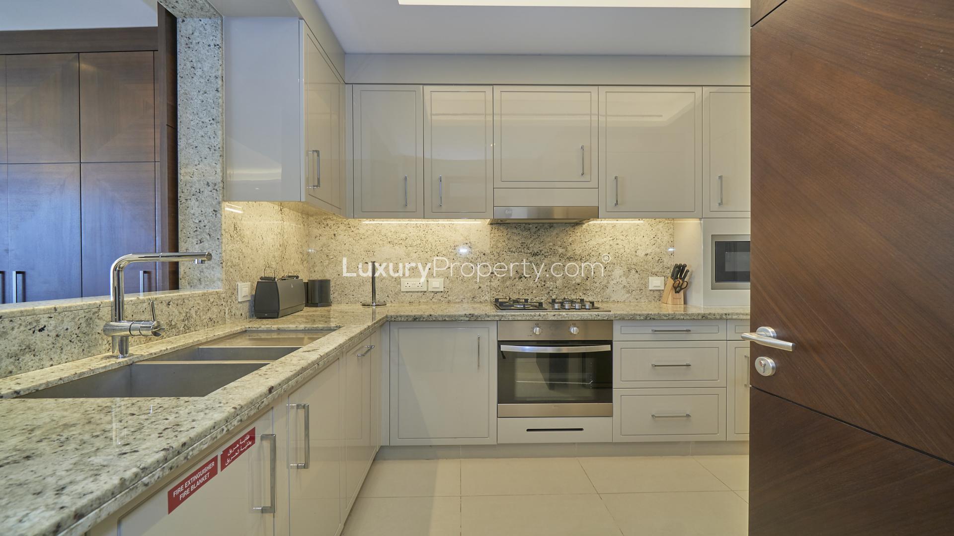 "Balcony view of Burj Khalifa from apartment in The Address Sky View Towers, Downtown Dubai.",Modern kitchen in spacious Downtown Dubai apartment, Address Sky View Towers, granite countertops