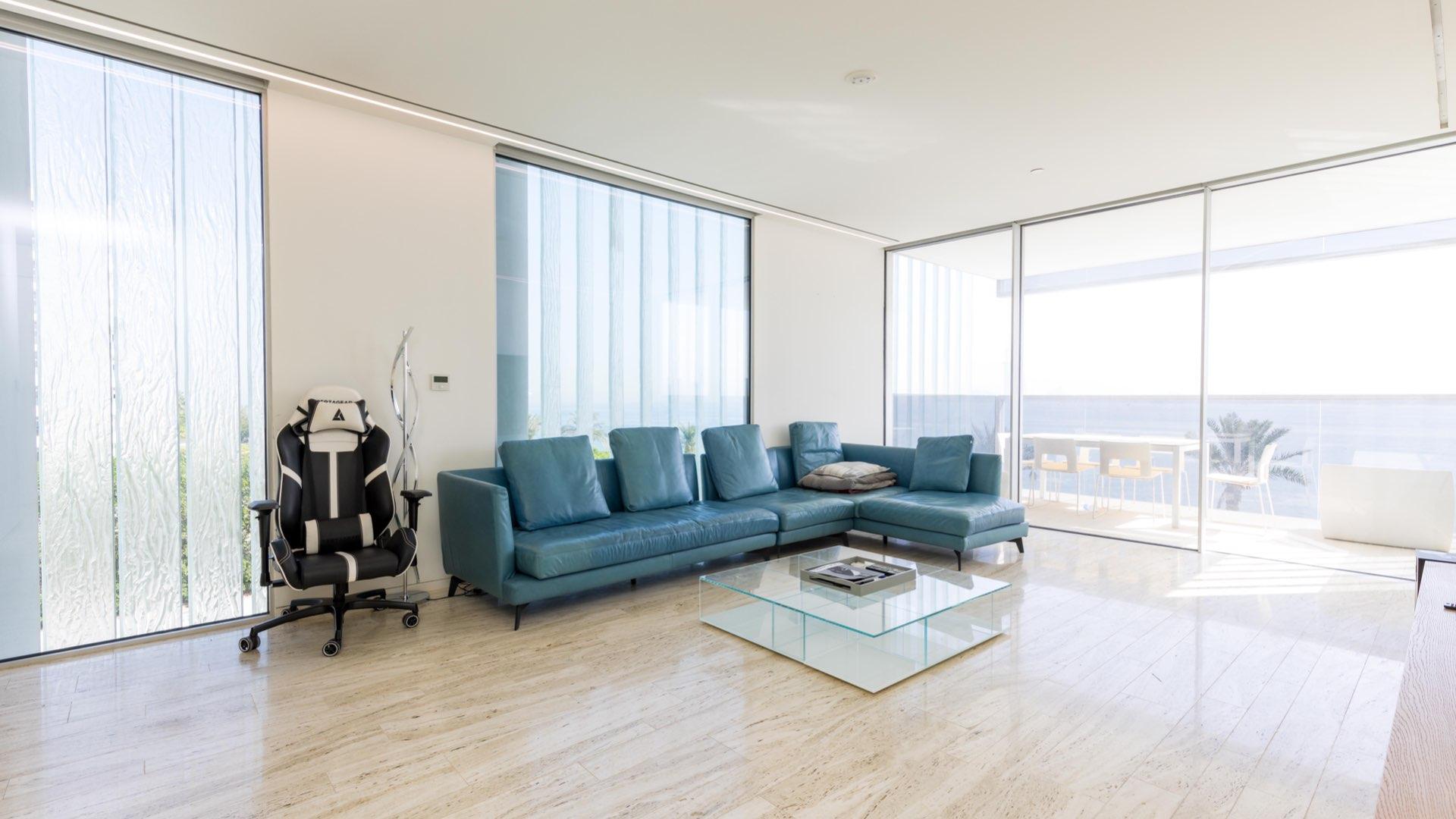 "Balcony with sea view from contemporary 2-bedroom apartment, Palm Jumeirah, The Crescent.",Contemporary furnished living room with sea view, Palm Jumeirah apartment for sale