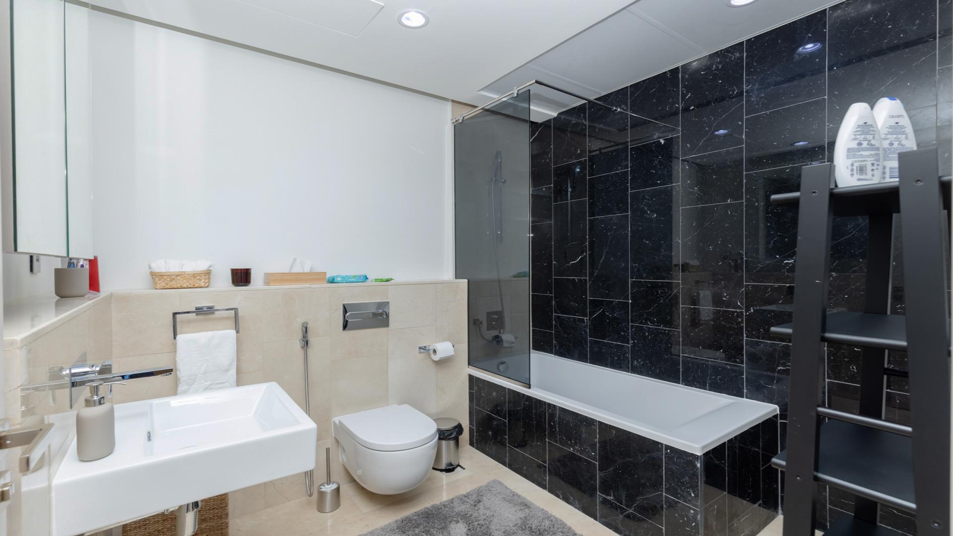 Luxurious Palm Jumeirah apartment bedroom with sea view, designer furniture, and modern upgrades