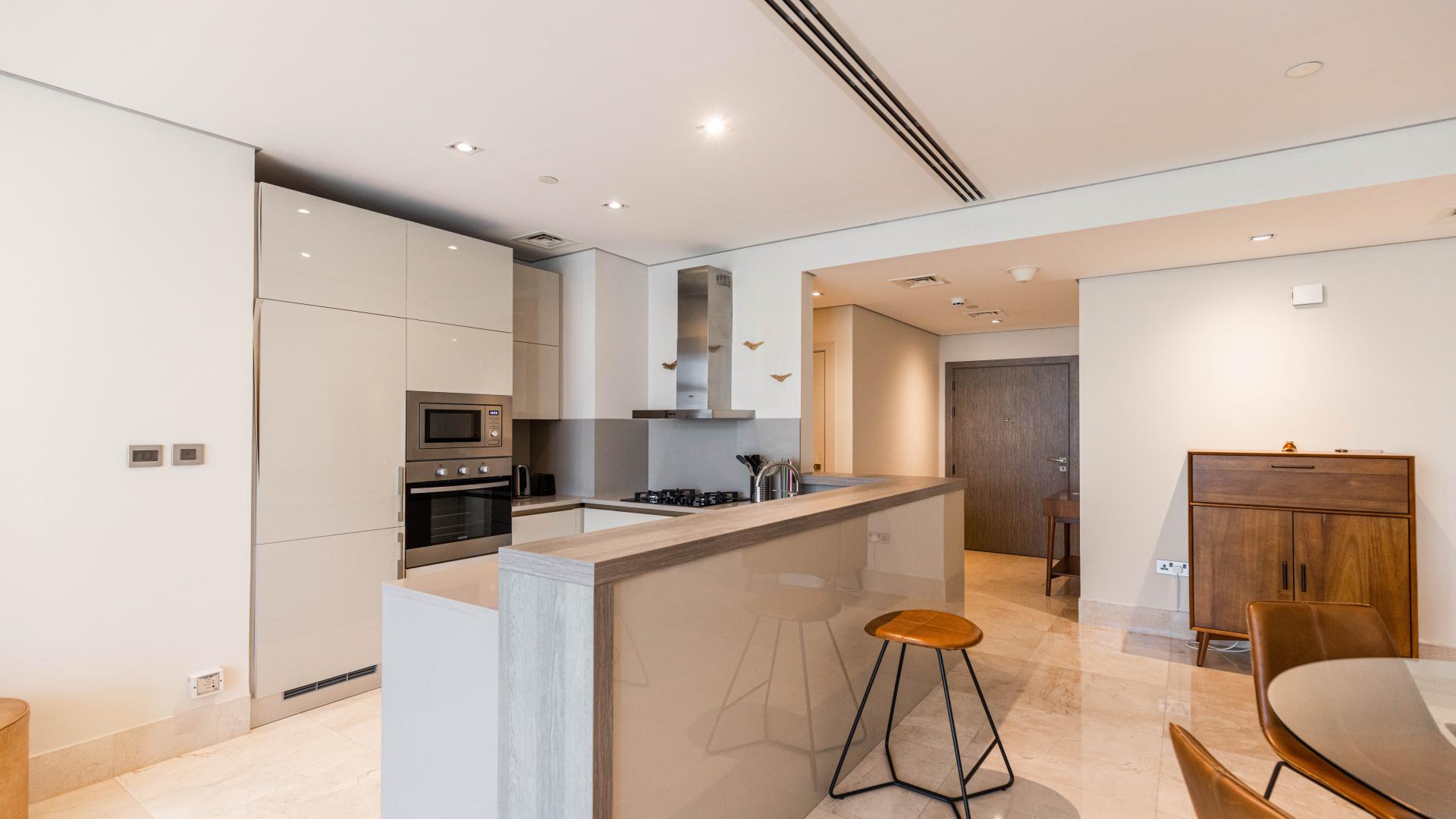 Modern kitchen in luxury beachfront apartment, Palm Jumeirah, with sleek design and high-end appliances