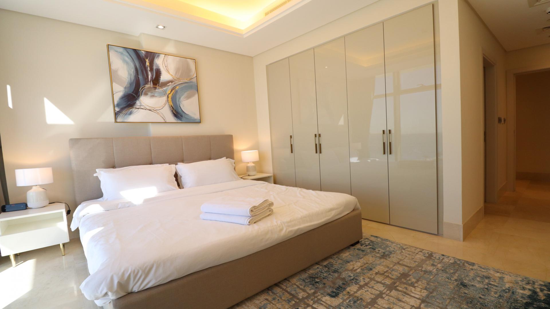 Luxury bathroom with dual sinks and elegant black marble accents in Palm Jumeirah apartment