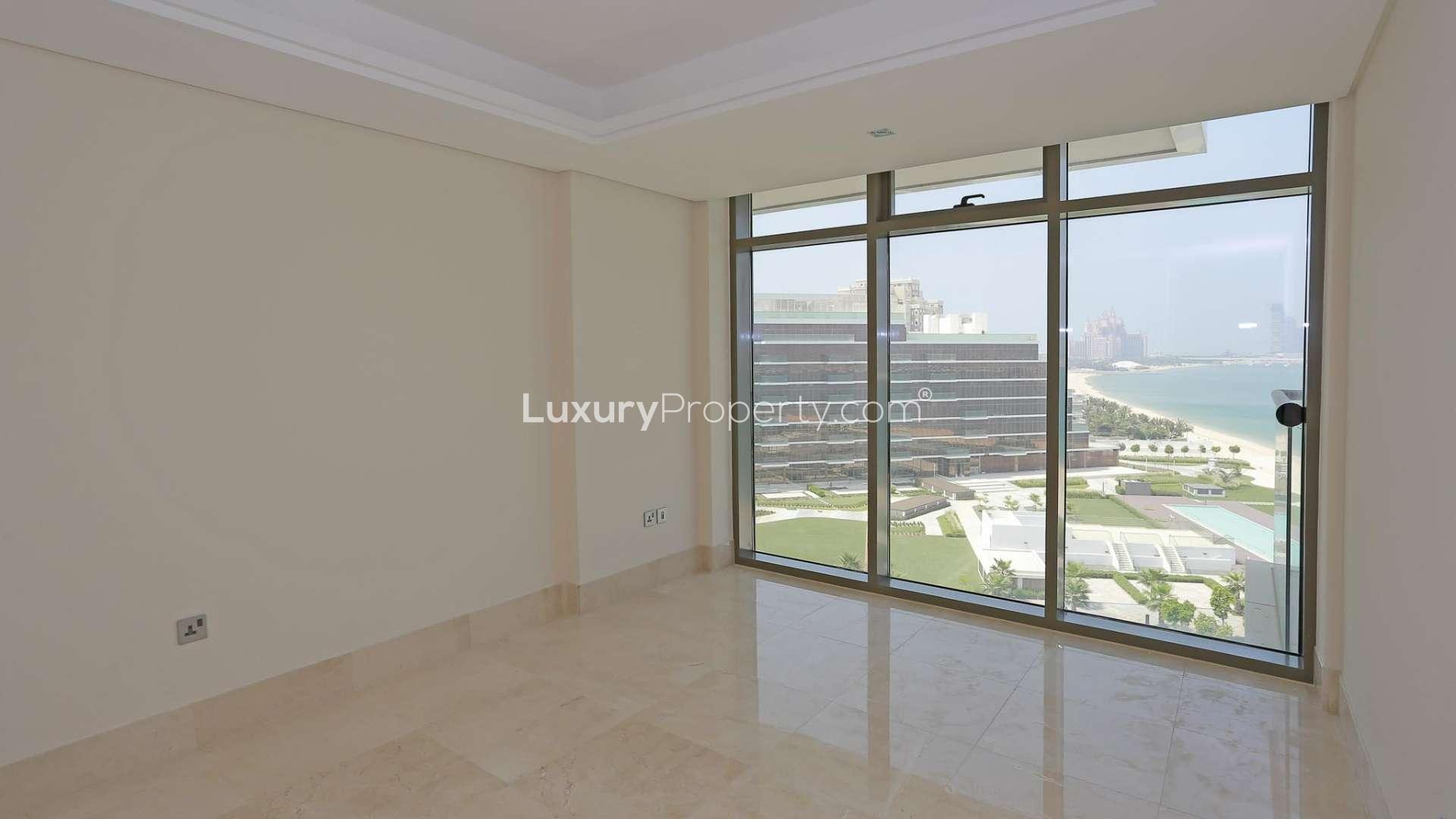 Modern kitchen in high-floor Palm Jumeirah apartment, featuring sleek cabinetry and marble flooring