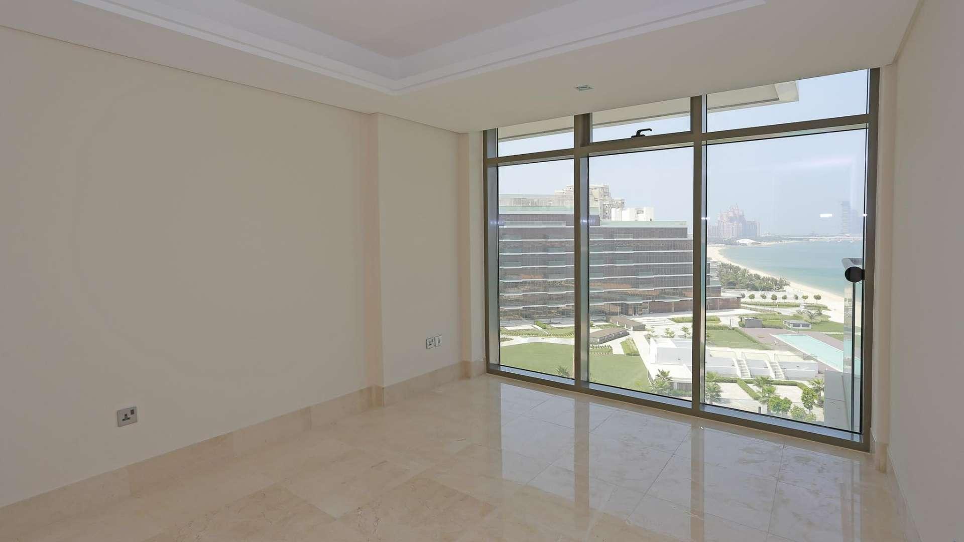 Modern kitchen in high-floor Palm Jumeirah apartment, featuring sleek cabinetry and marble flooring