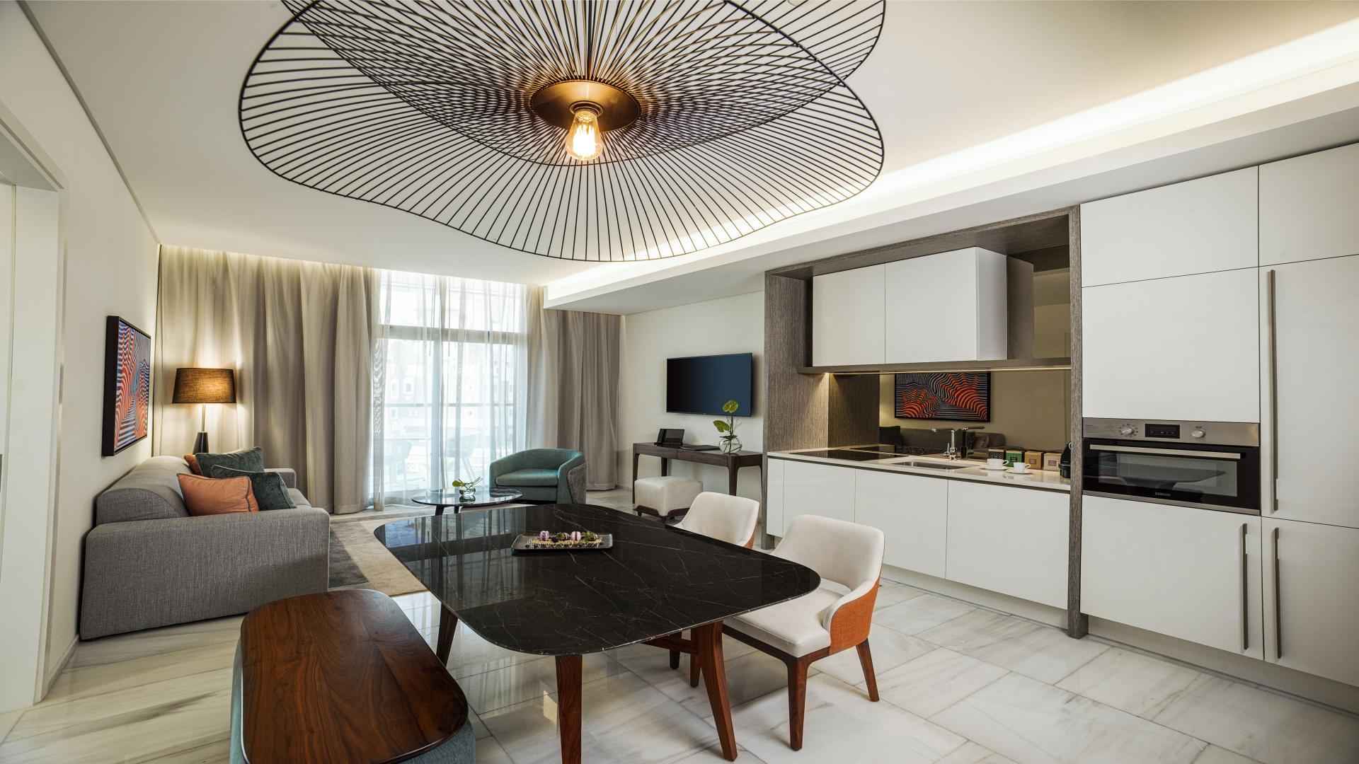 Spacious furnished apartment living room with modern decor, Palm Jumeirah view, for sale