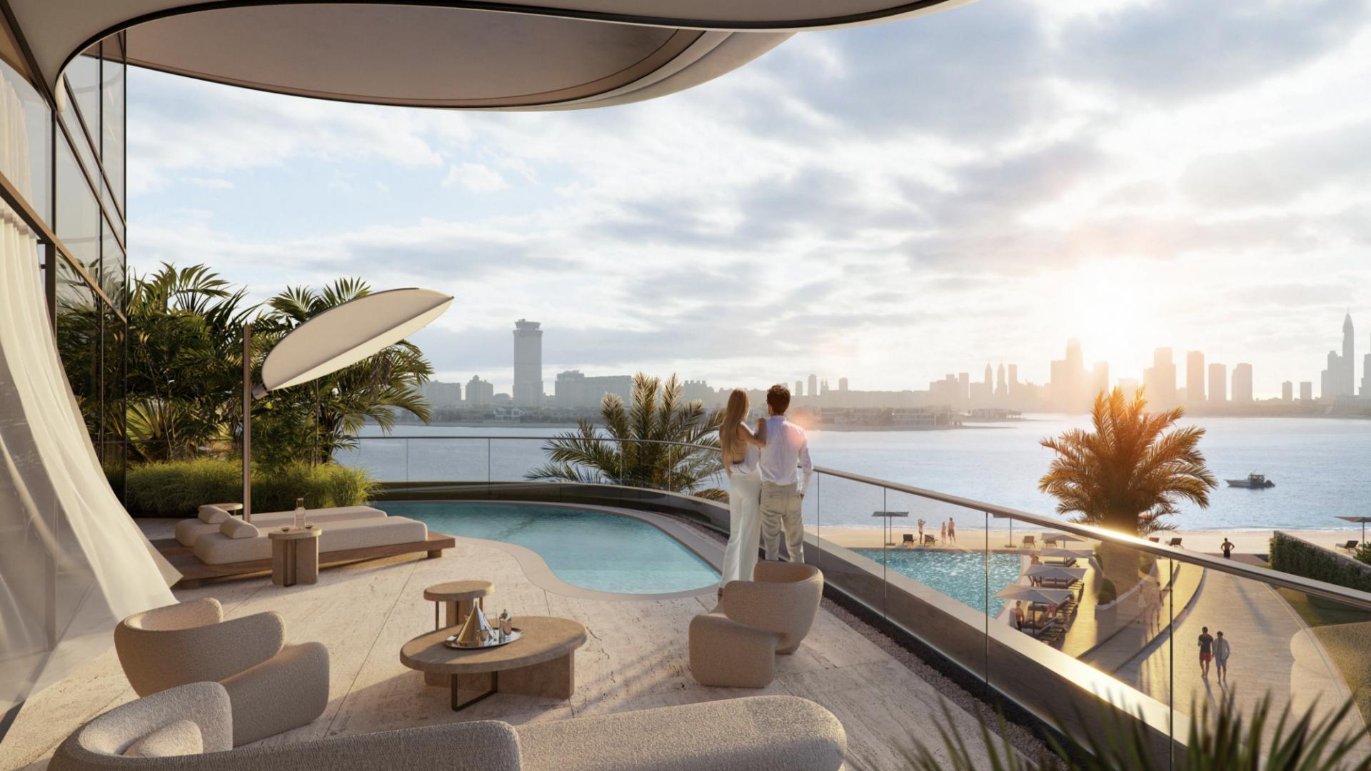 Luxury apartment exterior with pool in SLS Residences The Palm, Dubai at sunset