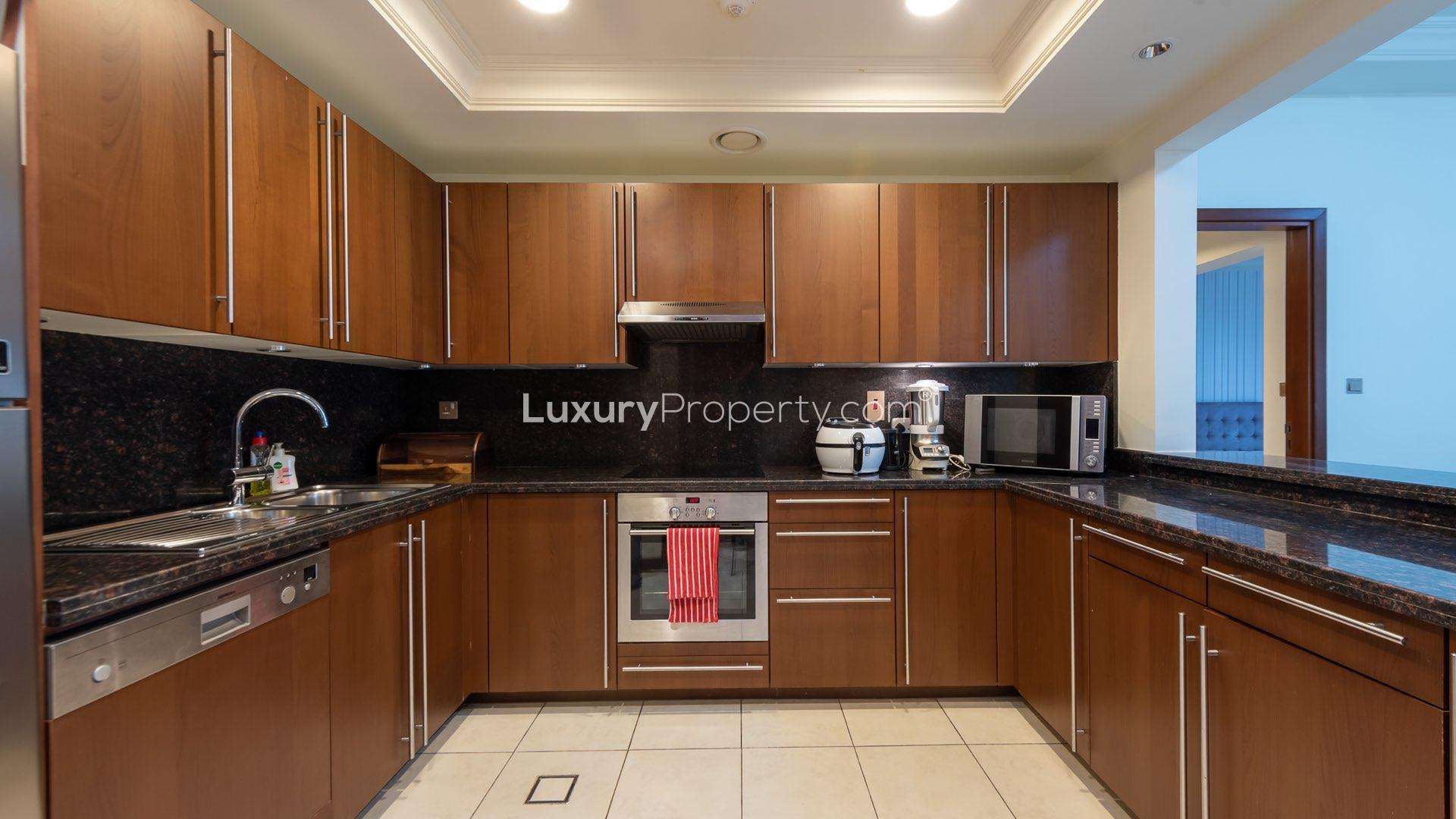 Modern kitchen and dining area in Fairmont South apartment, Palm Jumeirah for sale