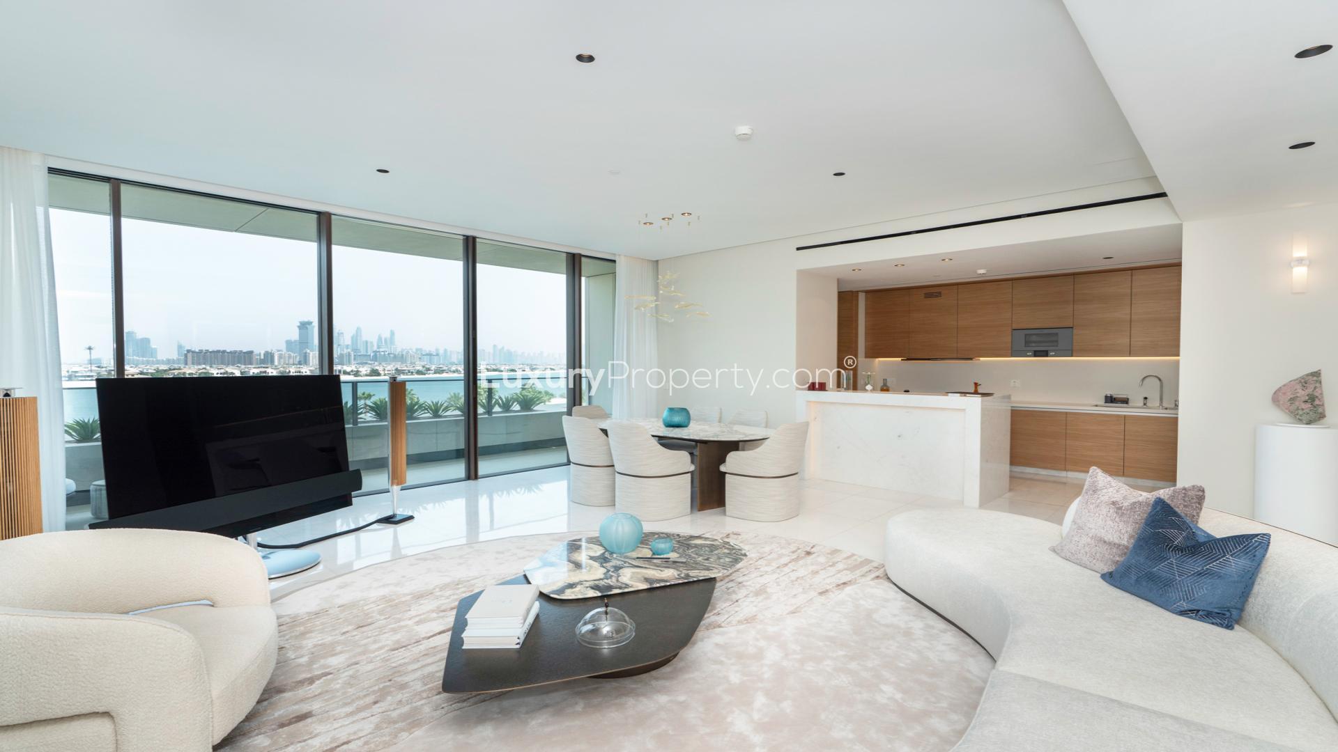 Upgraded Palm Jumeirah apartment living room with ocean view, modern furnishings, and elegant decor