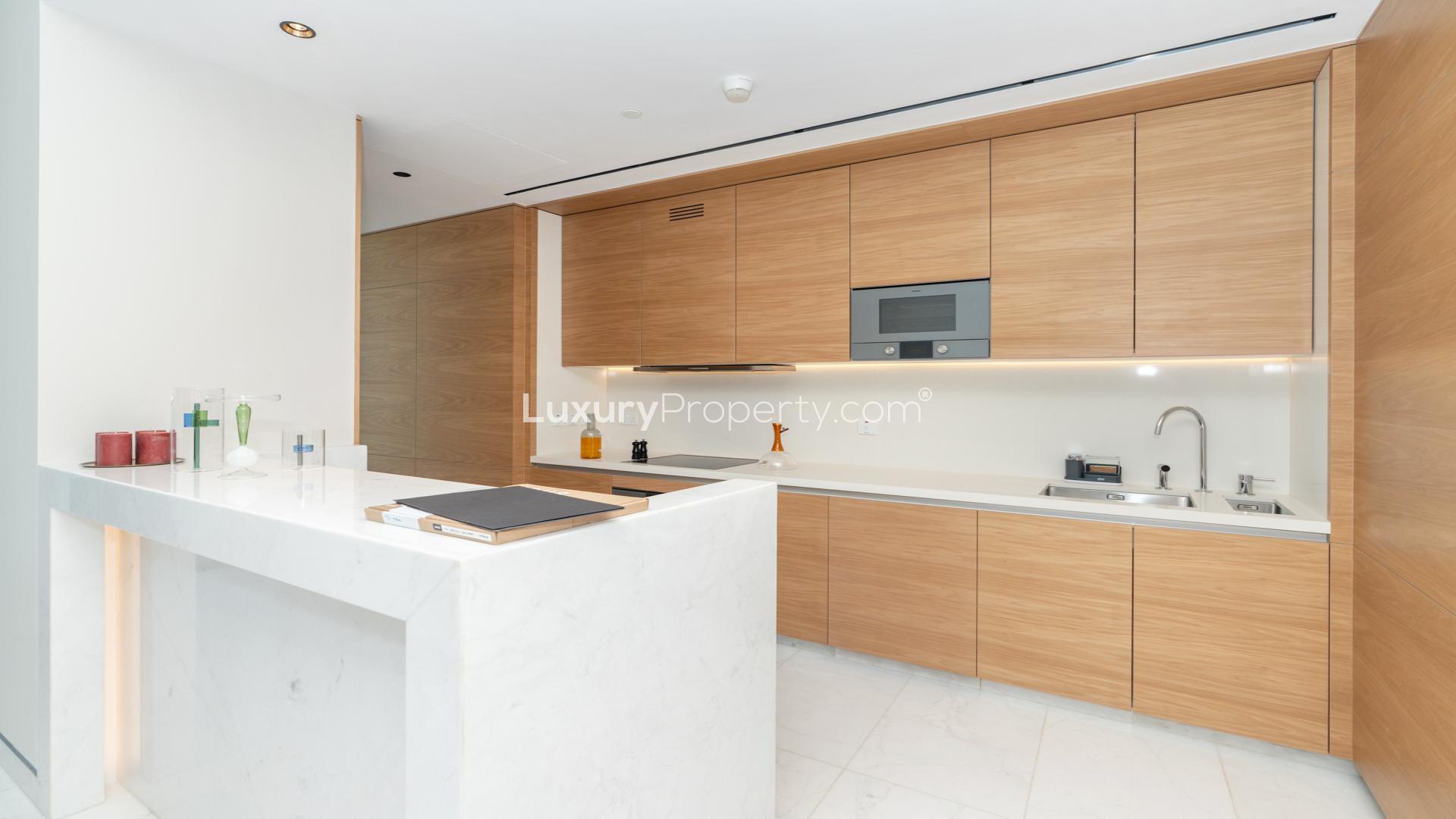 Upgraded Palm Jumeirah apartment living room with ocean view, modern furnishings, and elegant decor