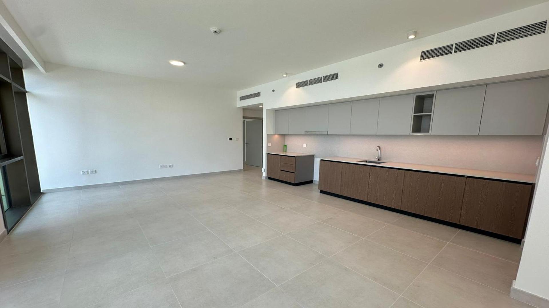 Empty living room in Creek Palace apartment, Dubai Creek Harbour with large window view