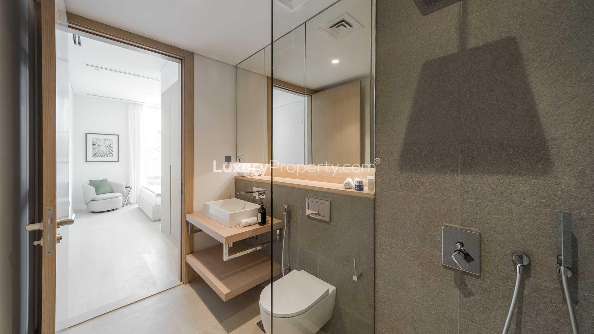 Modern bathroom with glass shower in luxury Al Barari apartment for sale, LP01271