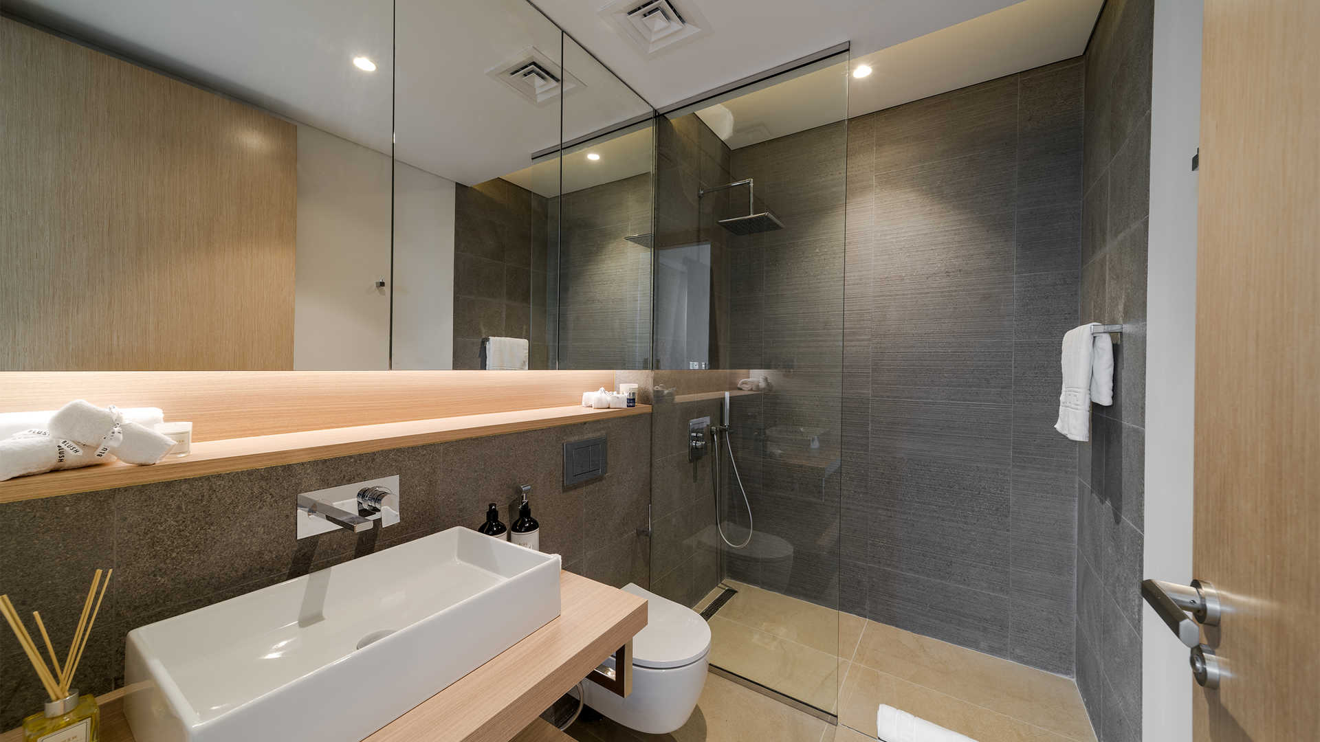 Luxury modern apartment exterior with lush landscaping at The Neighbourhood, Al Barari for sale