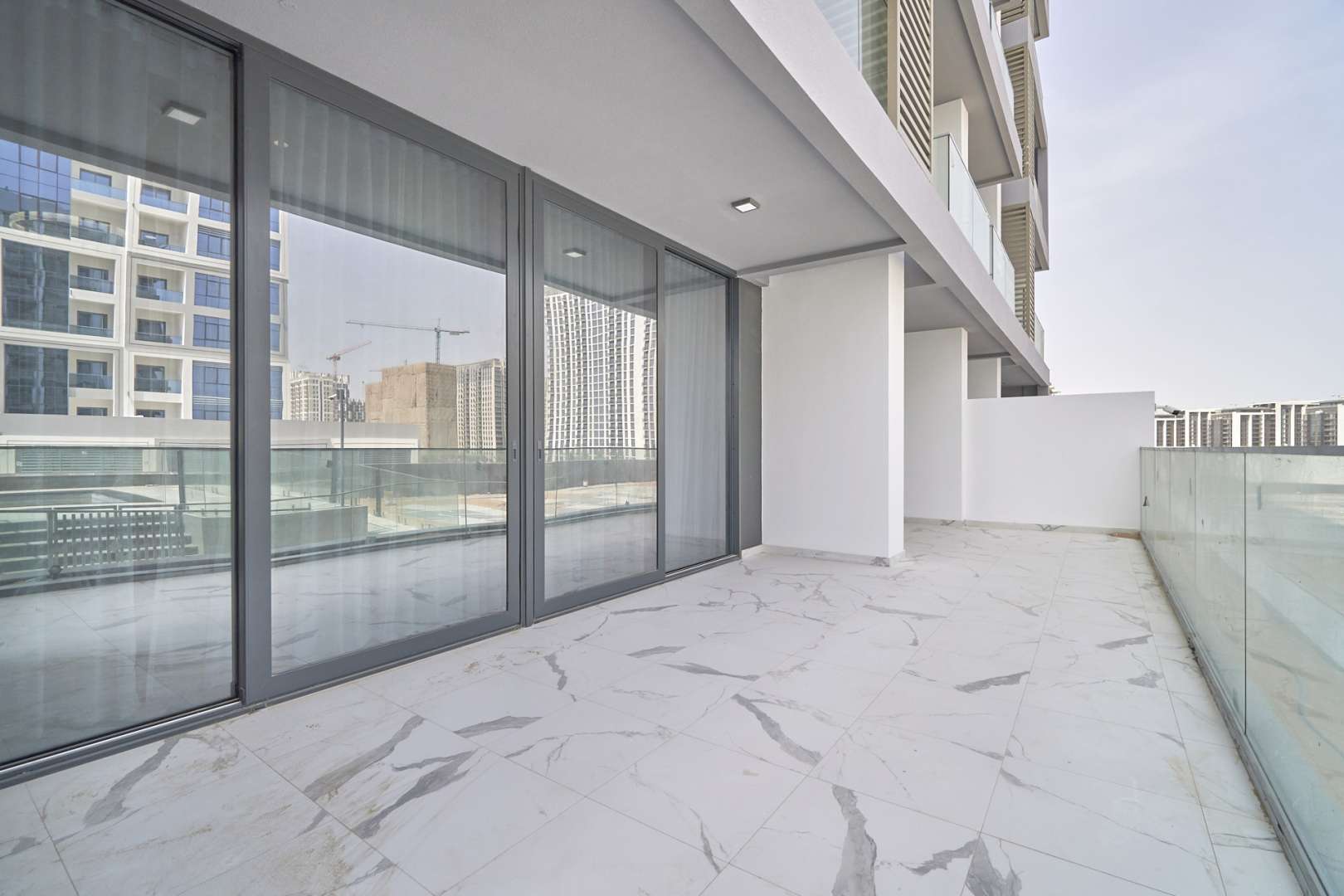 Modern kitchen and living area in two-bedroom apartment, Pinnacle Tower, Dubai Hills Estate