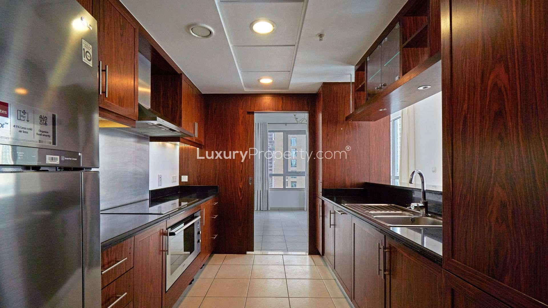 Modern kitchen in Downtown Dubai apartment, featuring sleek cabinetry and stainless steel appliances