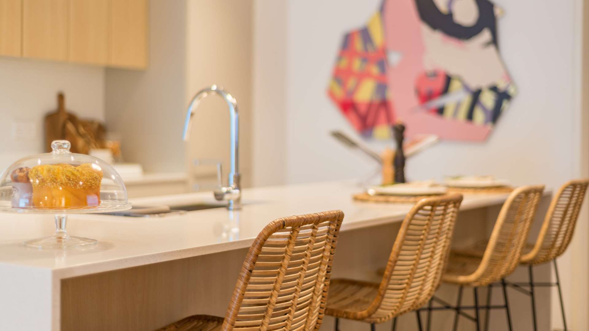 Modern kitchen island with wicker chairs in JVC apartment, The Sloane, for sale