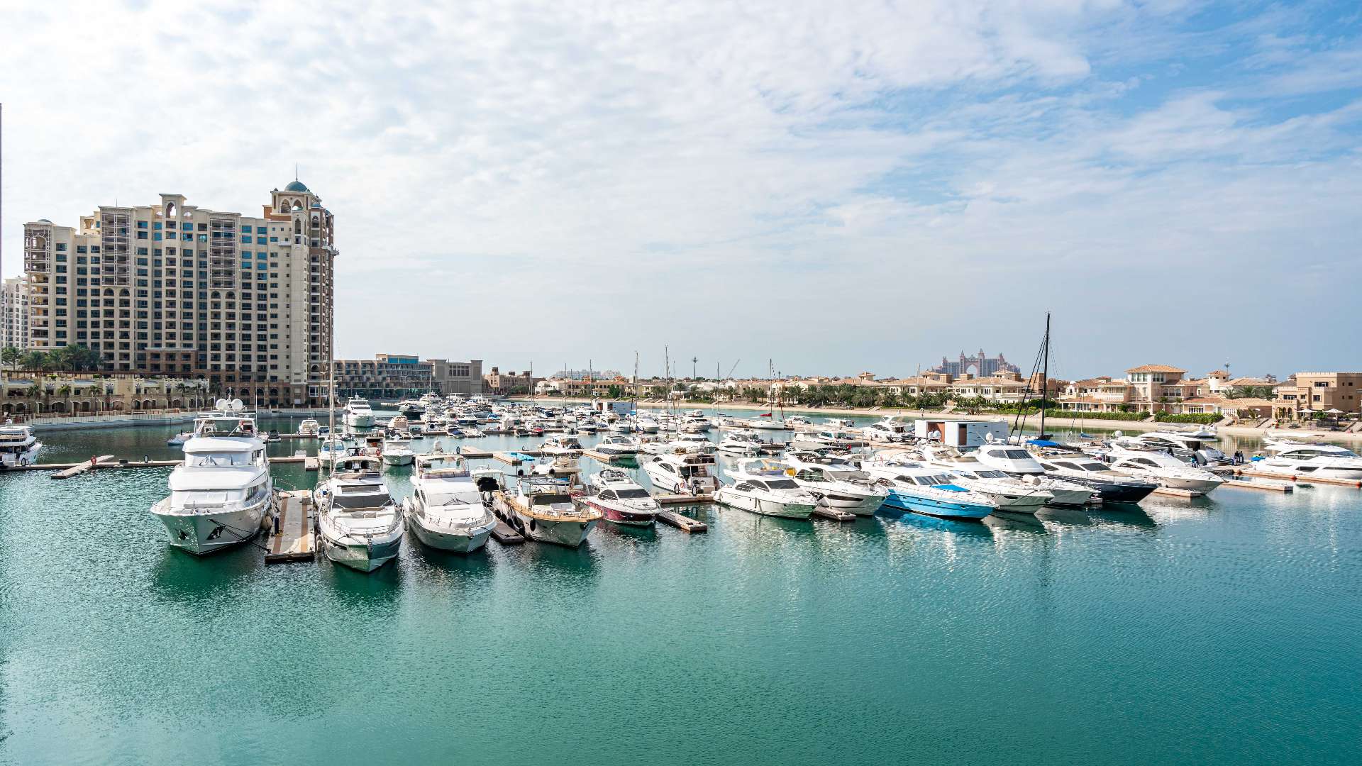 Beachfront view from luxury apartment in Tiara Residences, Palm Jumeirah, with loungers and kayaks
