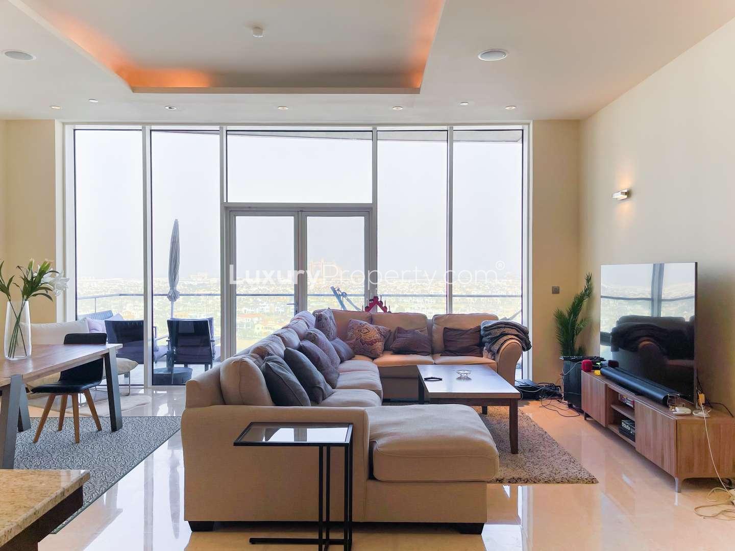 Modern living room in Tiara Residences apartment, Palm Jumeirah, with large windows and cozy seating