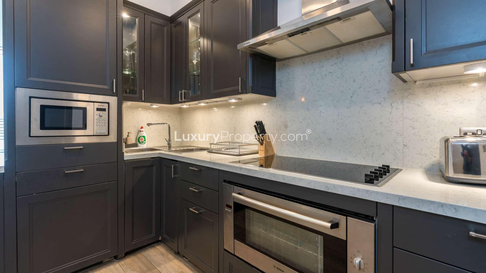 Modern kitchen interior in Tiara Residences apartment, Palm Jumeirah, featuring sleek design elements