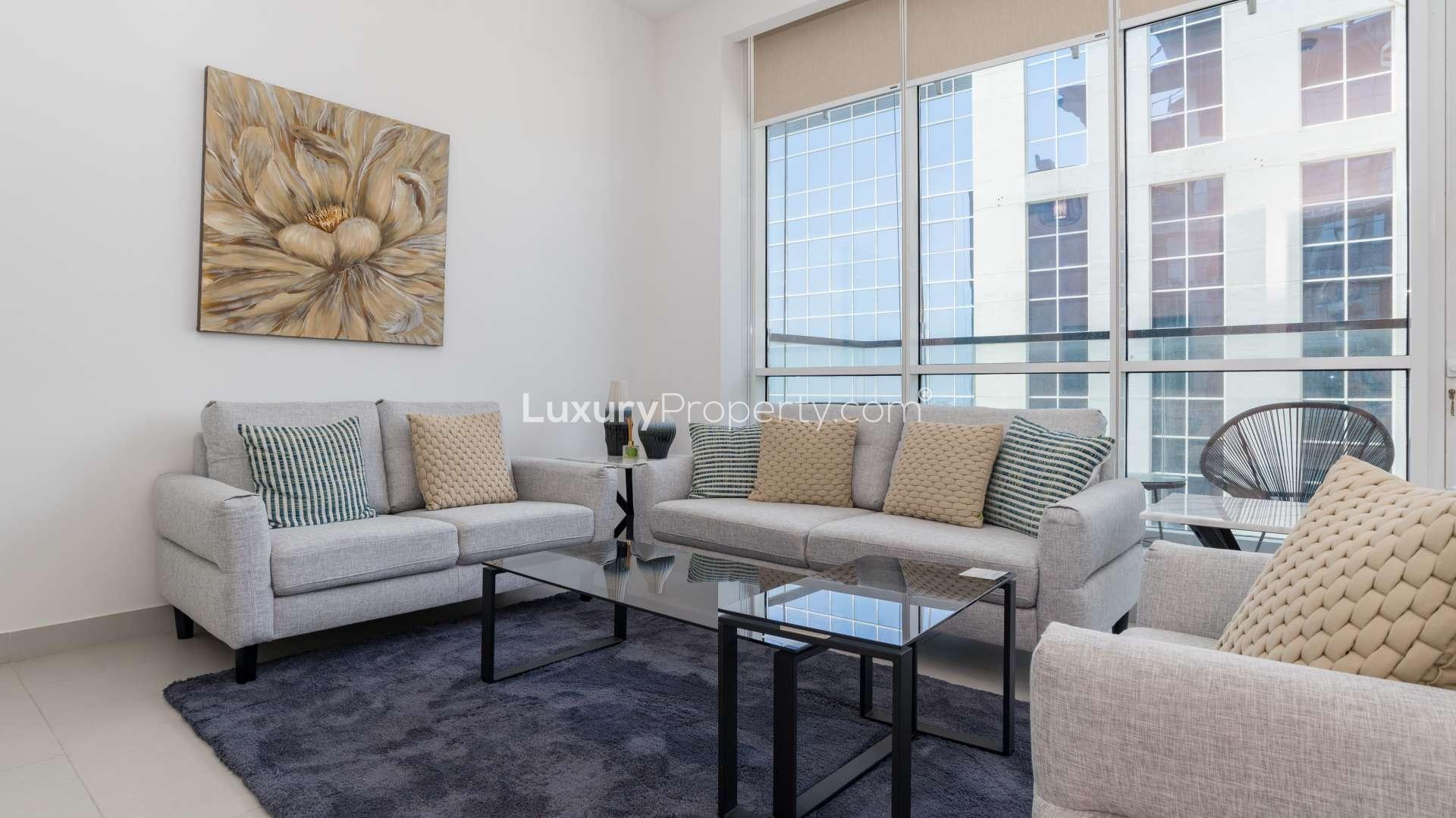 Modern living room in Vezul Residence apartment, Business Bay, with stylish decor and large windows