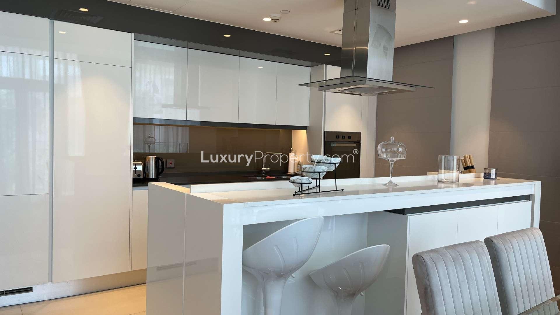 Ground-floor apartment terrace with garden view in Bluewaters Residences, wicker chair and swing