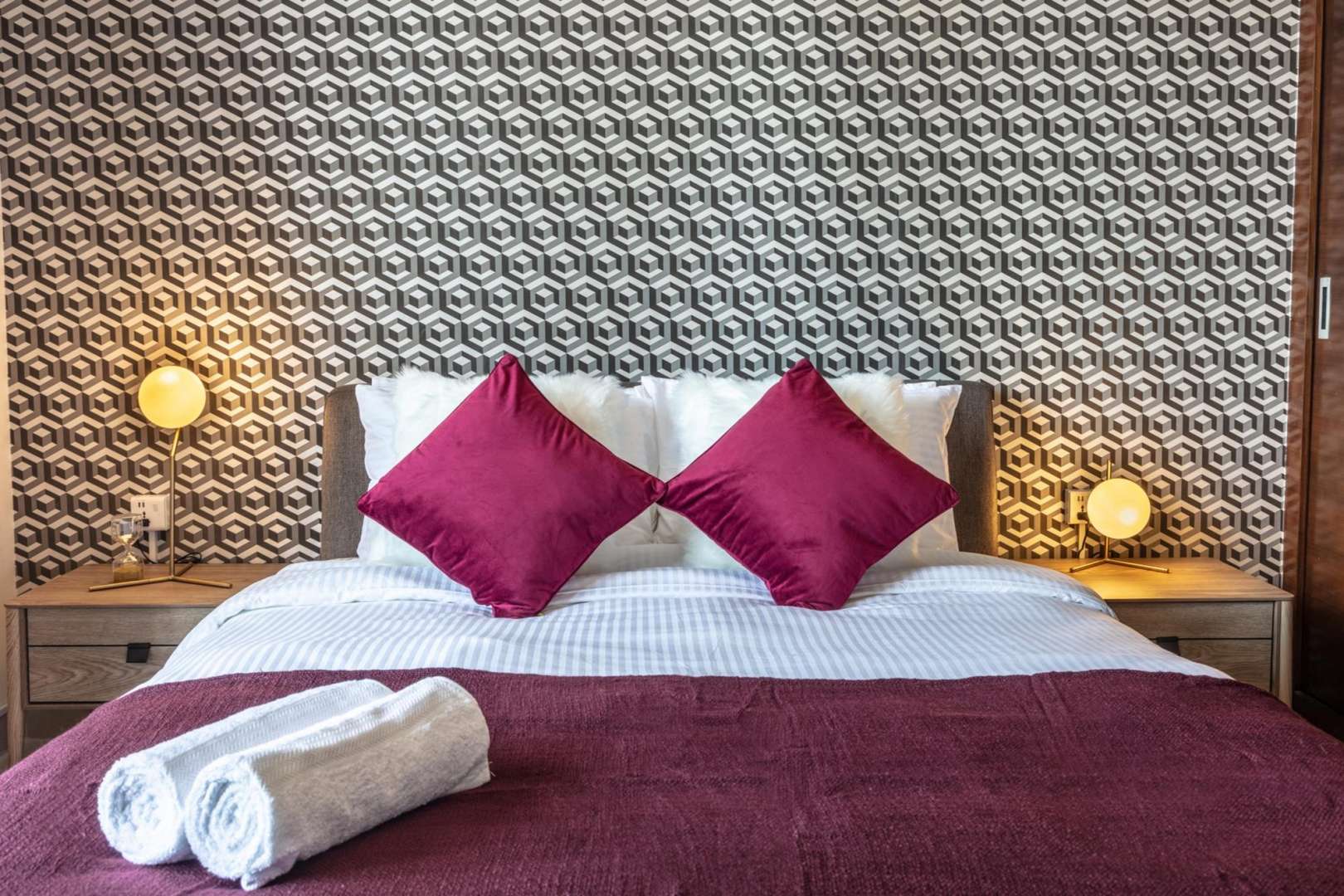 Dubai Marina view with Ferris wheel near Sparkle Towers apartment, lush greenery, and beachgoers