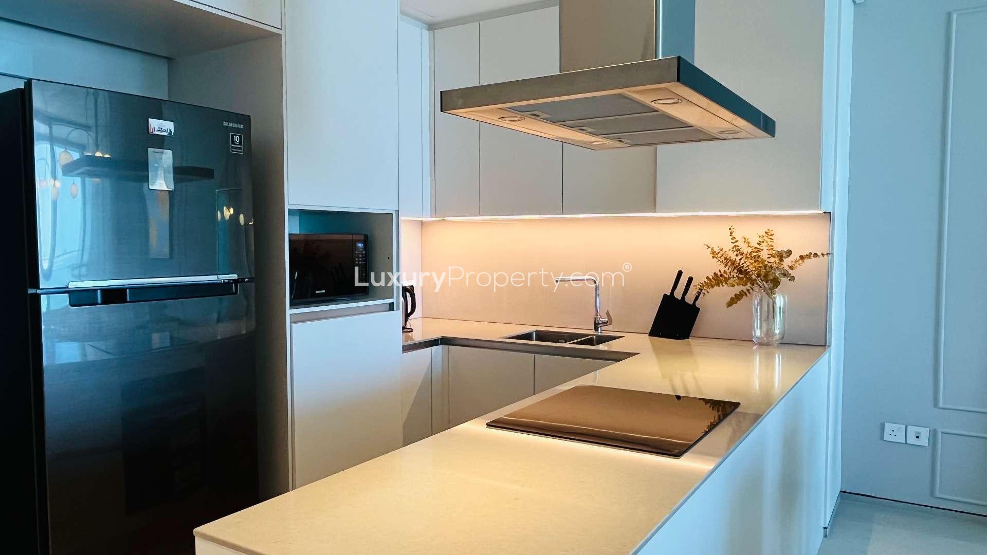 Modern kitchen in Address JBR apartment, featuring sleek design and high-end appliances