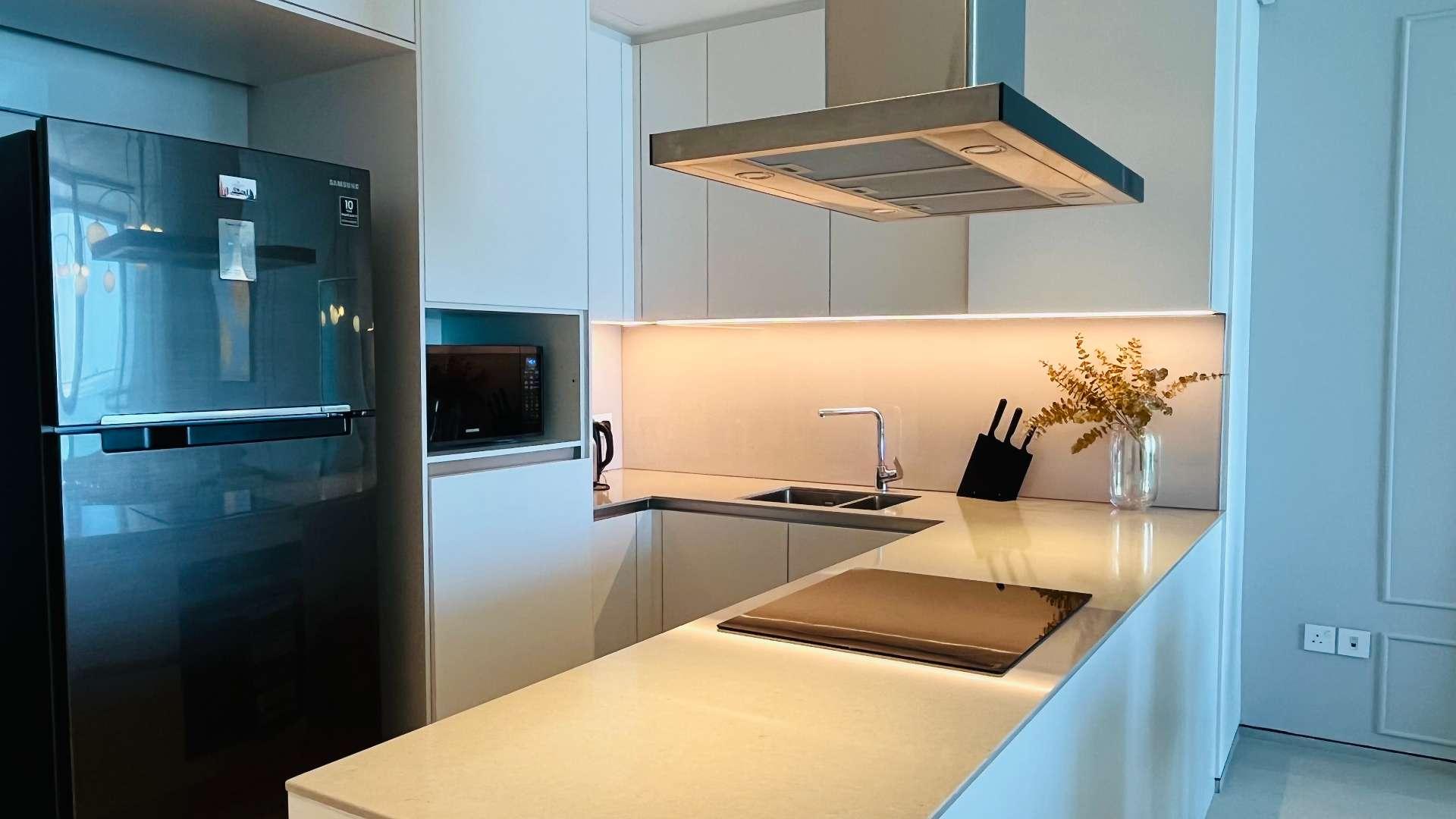 Modern kitchen in Address JBR apartment, featuring sleek design and high-end appliances