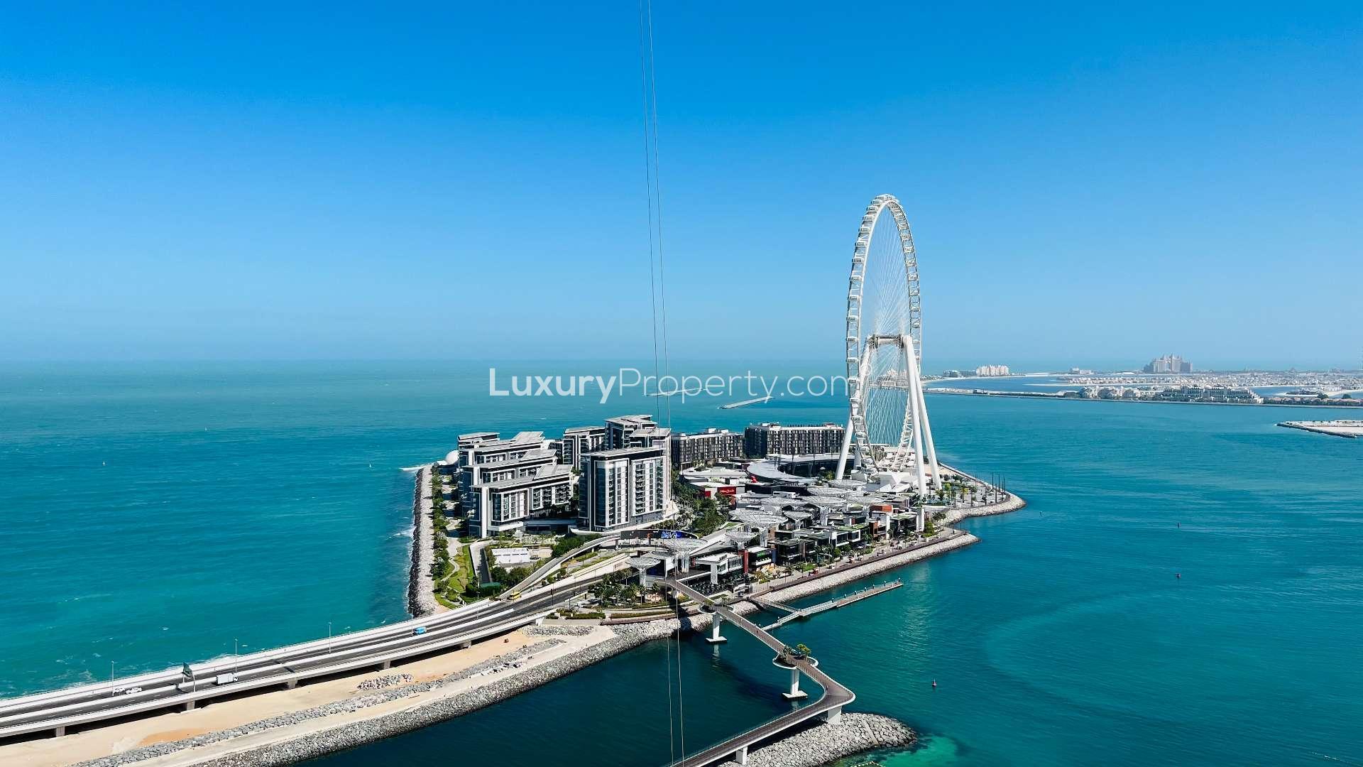 Modern living room in Address JBR apartment with sea view, glass table, and TV