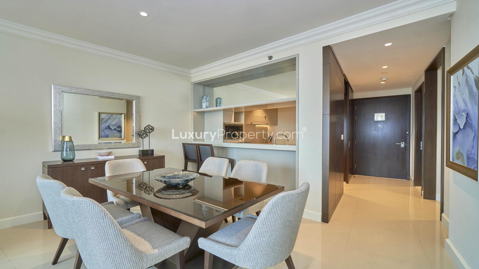 Modern Downtown Dubai apartment interior with Burj Khalifa view from living room, dining area