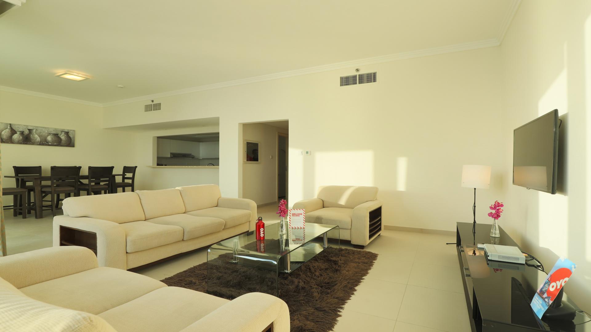 Modern living room in Jumeirah Beach Residence apartment, featuring elegant decor and ample seating
