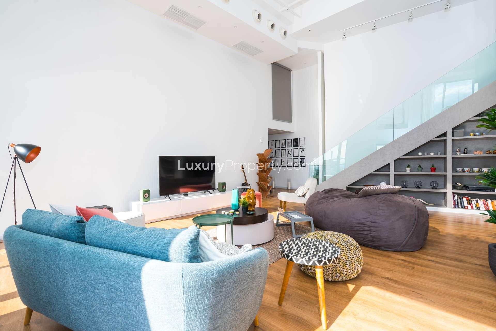 Modern living room in 2-bedroom loft apartment, Jumeirah Beach Residence, Dubai, with city views