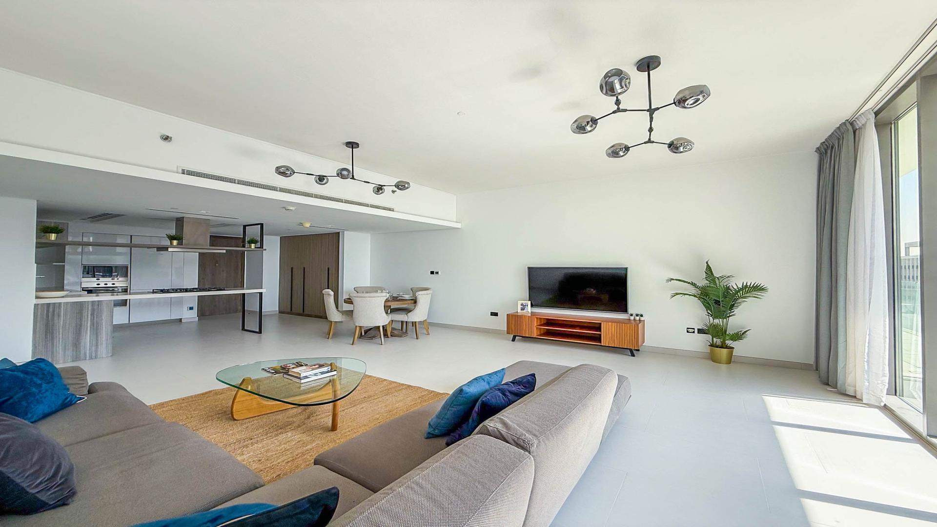 Modern living area in Soho Palm Jumeirah penthouse with open kitchen and natural light