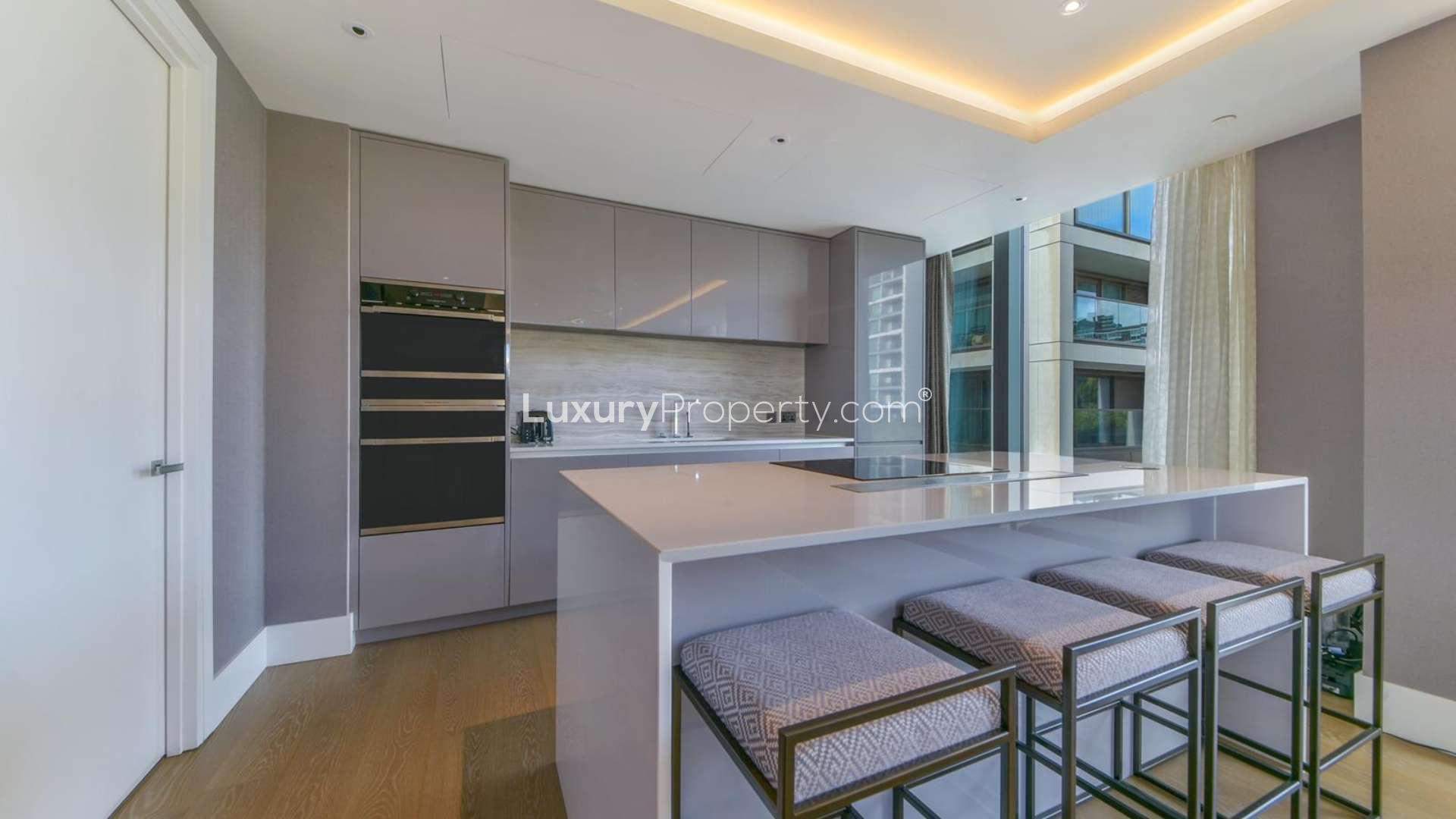 Elegant entrance of Kensington penthouse with mirrored wall and floral decor, Edward House