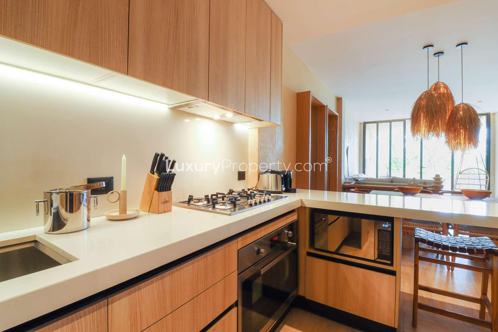 Dining area with wooden table in Garden Penthouse, The Village, Corasol Riviera Maya
