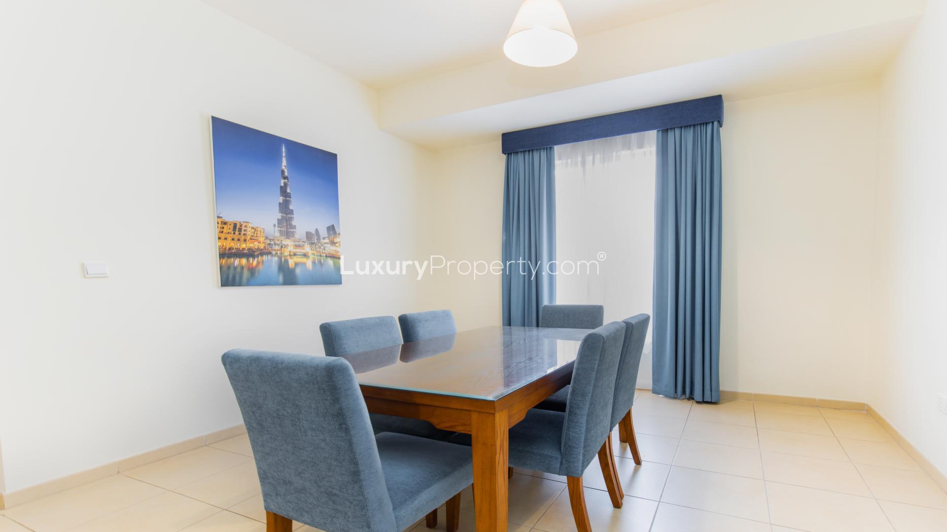 Living room in serviced apartment, Jumeirah Beach Residence, Amwaj. Cozy blue sofas, bright ambiance